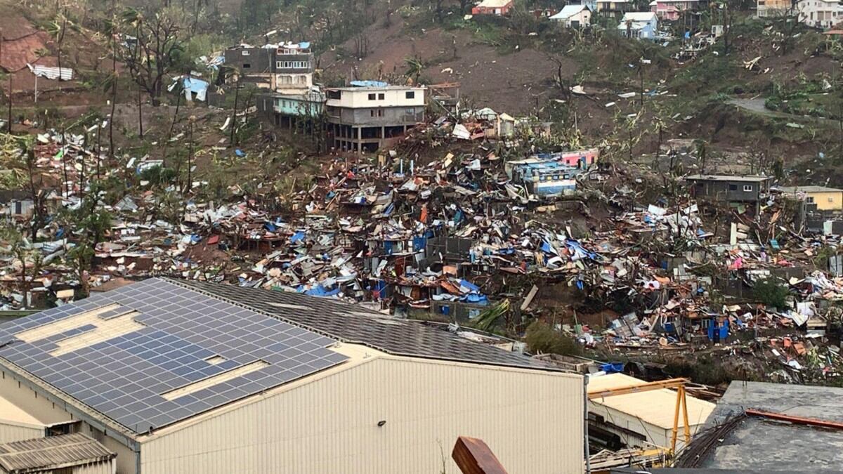 A photo taken on December 15, 2024 shows a pile of debris of metal sheets, wood, furniture and belongings after the cyclone Chido hit France's Indian Ocean territory of Mayotte. - At least 14 people were killed in Mayotte when a fierce cyclone battered the French Indian Ocean territory, authorities said on December 15, 2024, with officials warning it will take days to know the full toll. (Photo by KWEZI / AFP)