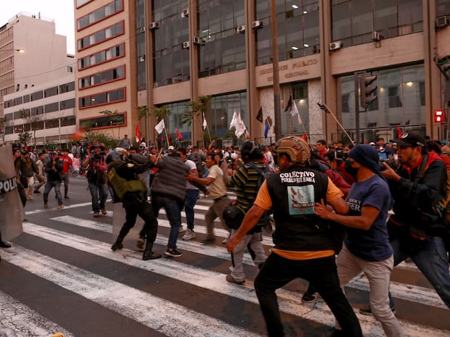 LIMA, PERU - Demonstrators clash with police during a protest demanding presidential elections, the release of Pedro Castillo and the closure of Congress after ousted Peruvian leader Pedro Castillo was detained in a police prison following his removal from office, in Lima, Peru, December 9, 2022 (Photo by Klebher Vasquez/Anadolu Agency via Getty Images)
