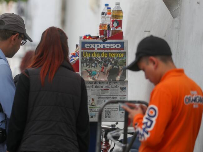 Personas leen las portadas de los periódicos hoy, en Quito (Ecuador). Los Estados miembros del Mercosur condenaron enérgicamente los actos de violencia perpetrados por el crimen organizado en Ecuador, según un comunicado difundido este miércoles por la Cancillería brasileña. EFE/ José Jácome