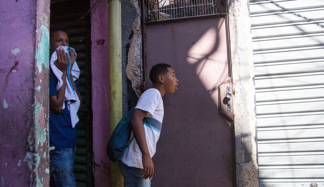 Jóvenes en Río de Janeiro esperan a que terminen los enfrentamientos para poder salir de su casa.