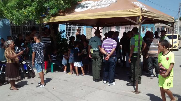 Los vecinos y amigos en las afueras de la casa del patrullero en el barrio Rebolo