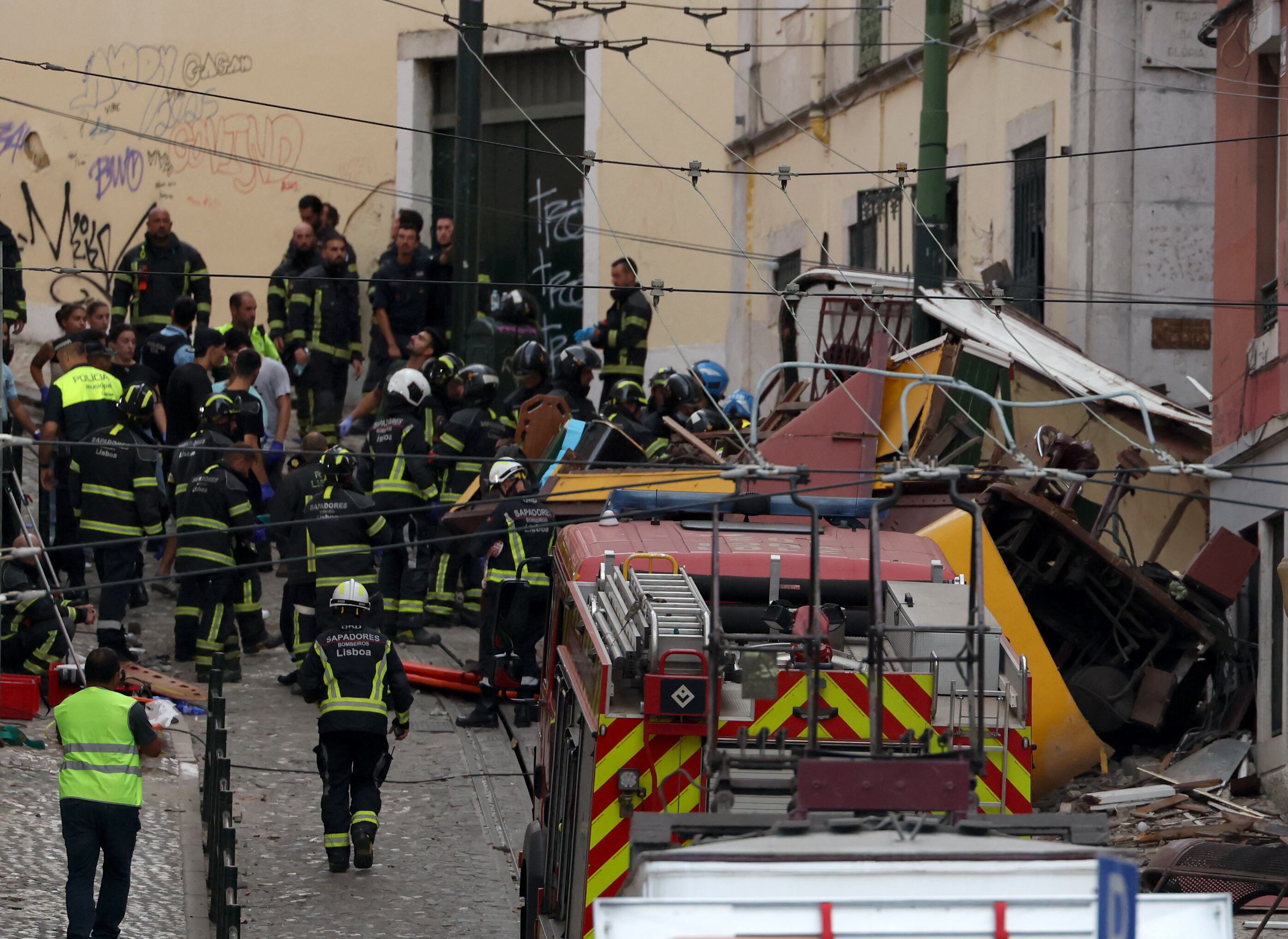 Police and firefighters work on the site of a funicular railway accident in Lisbon, on September 3, 2025. The accident of a funicular railway caused several dead and seriously injured in Lisbon, announced the Portugal's President of the Republic. (Photo by PATRICIA DE MELO MOREIRA / AFP)