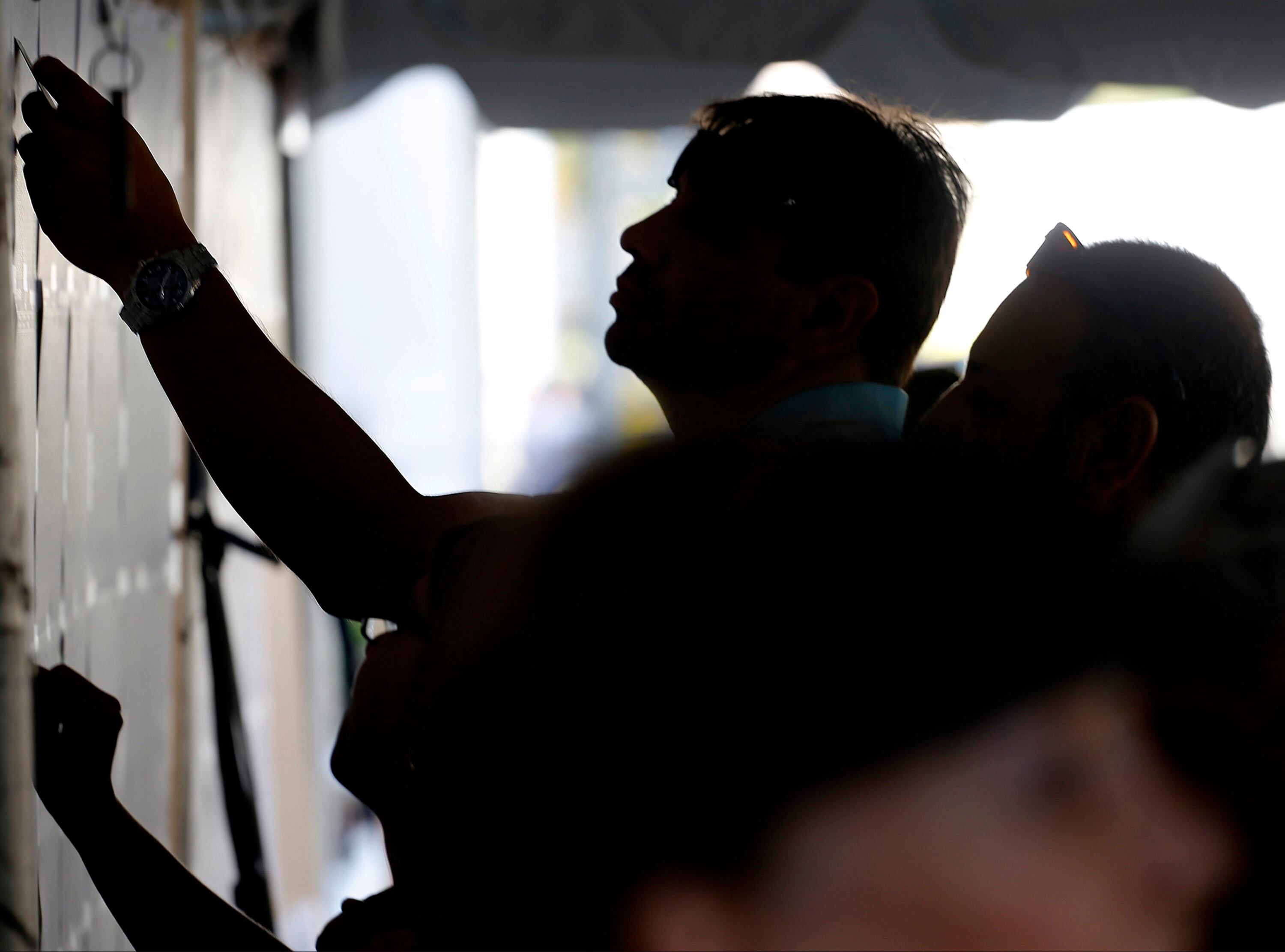 Voters search for the location of their voting booth on Sunday, Oct. 2, 2016 at the Colombian Consulate in Coral Gables, Fla. (Carl Juste/Miami Herald/Tribune News Service via Getty Images)