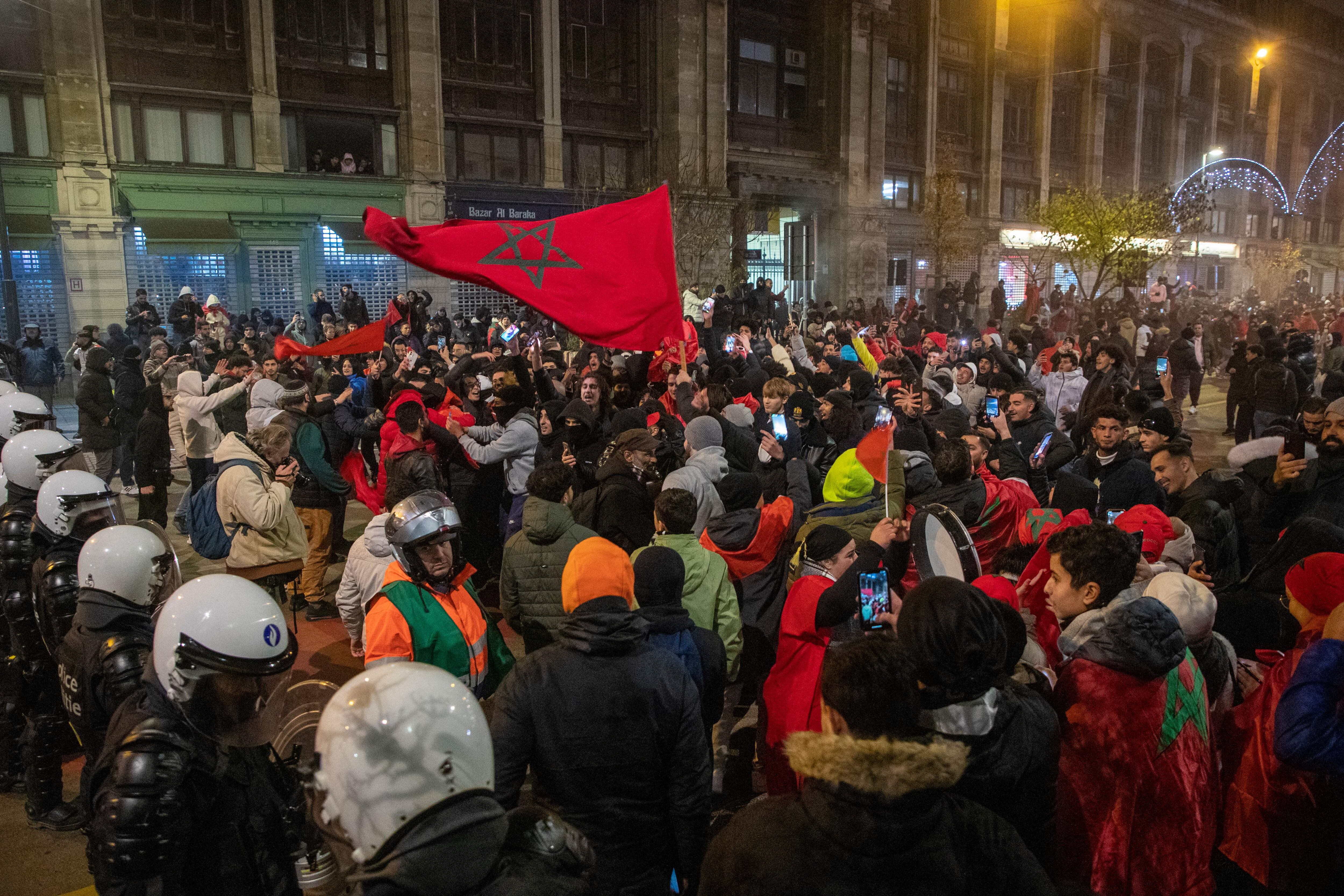 Morocco's supporters gather as they celebrate victory at the end of the Qatar 2022 World Cup quarter-final football match between Morocco and Portugal, in Brussels on December 10, 2022. - Morocco became the first African team ever to reach the semi-finals of the World Cup after defeating Portugal 1-0 on Saturday. - Belgium OUT (Photo by NICOLAS MAETERLINCK / BELGA / AFP) / Belgium OUT (Photo by NICOLAS MAETERLINCK/BELGA/AFP via Getty Images)