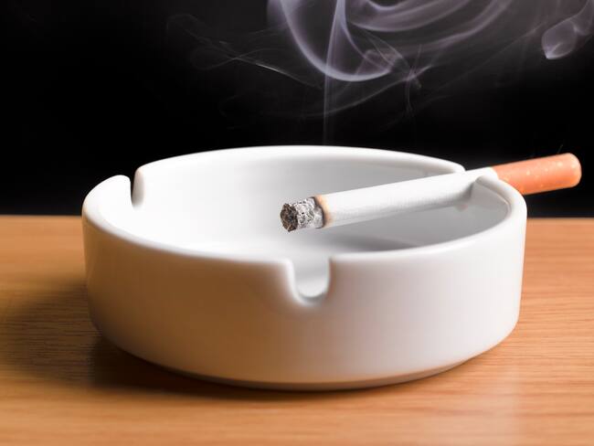 smoking cigarette, burning in ashtray