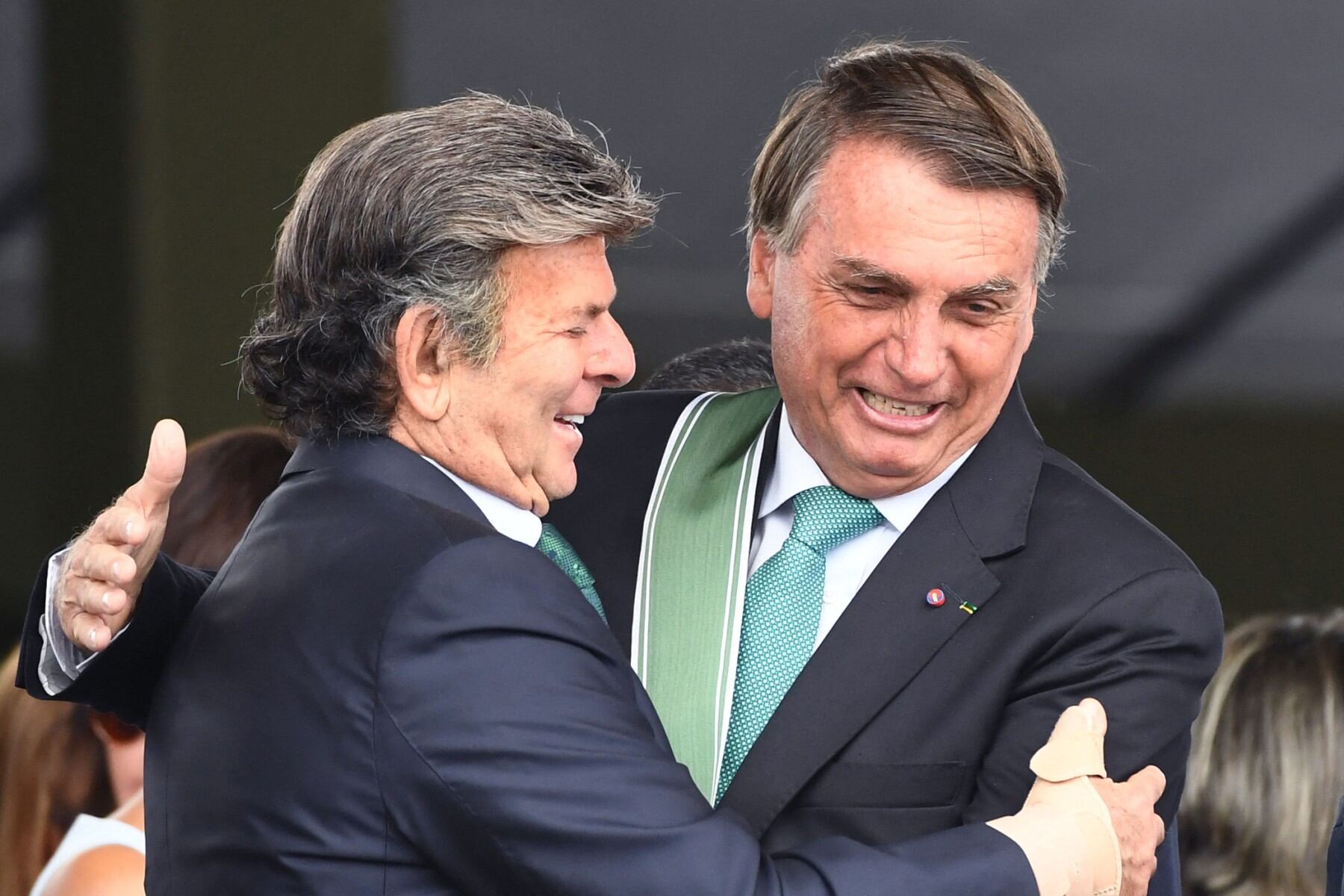 Brazilian President Jair Bolsonaro (R) and the President of the Supreme Court, Luiz Fux, greet each other during the Brazilian Army Day celebration at the Army Headquarters in Brasilia, on April 19, 2022 (Photo by EVARISTO SA / AFP)