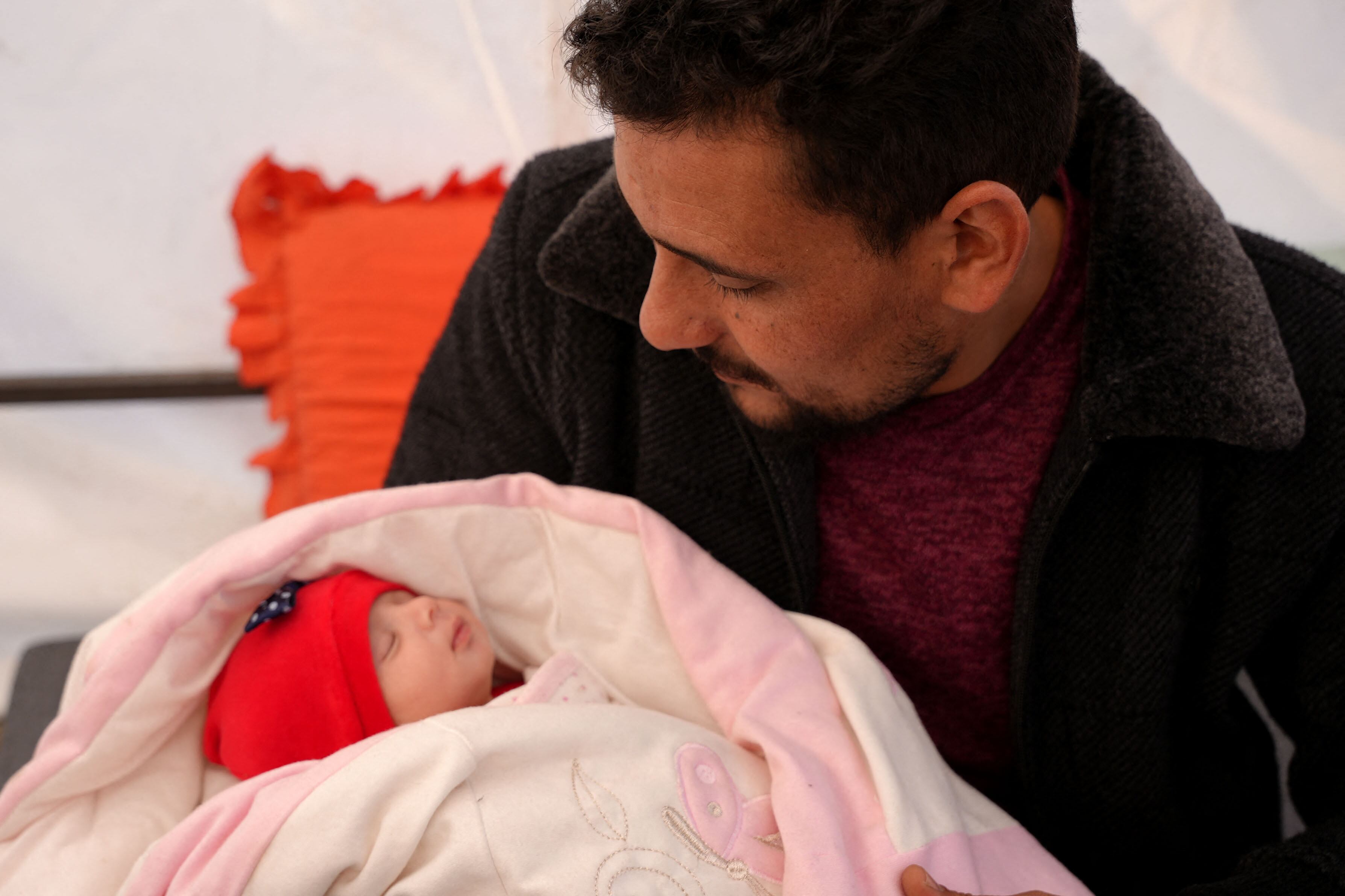 Khalil al-Suwadi holds his niece Afraa, a Syrian baby born under the rubble after the February 6 earthquake that hit Turkey and Syria killing her parents and siblings, in the rebel-held town of Jindayris in northern Syria, on February 21, 2023. - Suwadi took the baby girl in 10 days after she was admitted to hospital in the rebel-held city of Jandaires, near the border with Turkey, where medical staff performed a DNA test to make sure they were handing her to relatives. (Photo by Rami al SAYED / AFP) (Photo by RAMI AL SAYED/AFP via Getty Images)