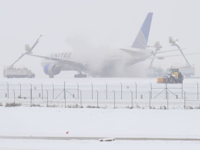 DENVER, COLORADO - JANUARY 15: Crews work to deice an airplane at Denver International Airport in Denver, Colorado on January 15, 2024. Over 320 flights have been canceled because of a winter storm that his the airport with snow and freezing temperatures. (Photo by RJ Sangosti/MediaNews Group/The Denver Post via Getty Images)