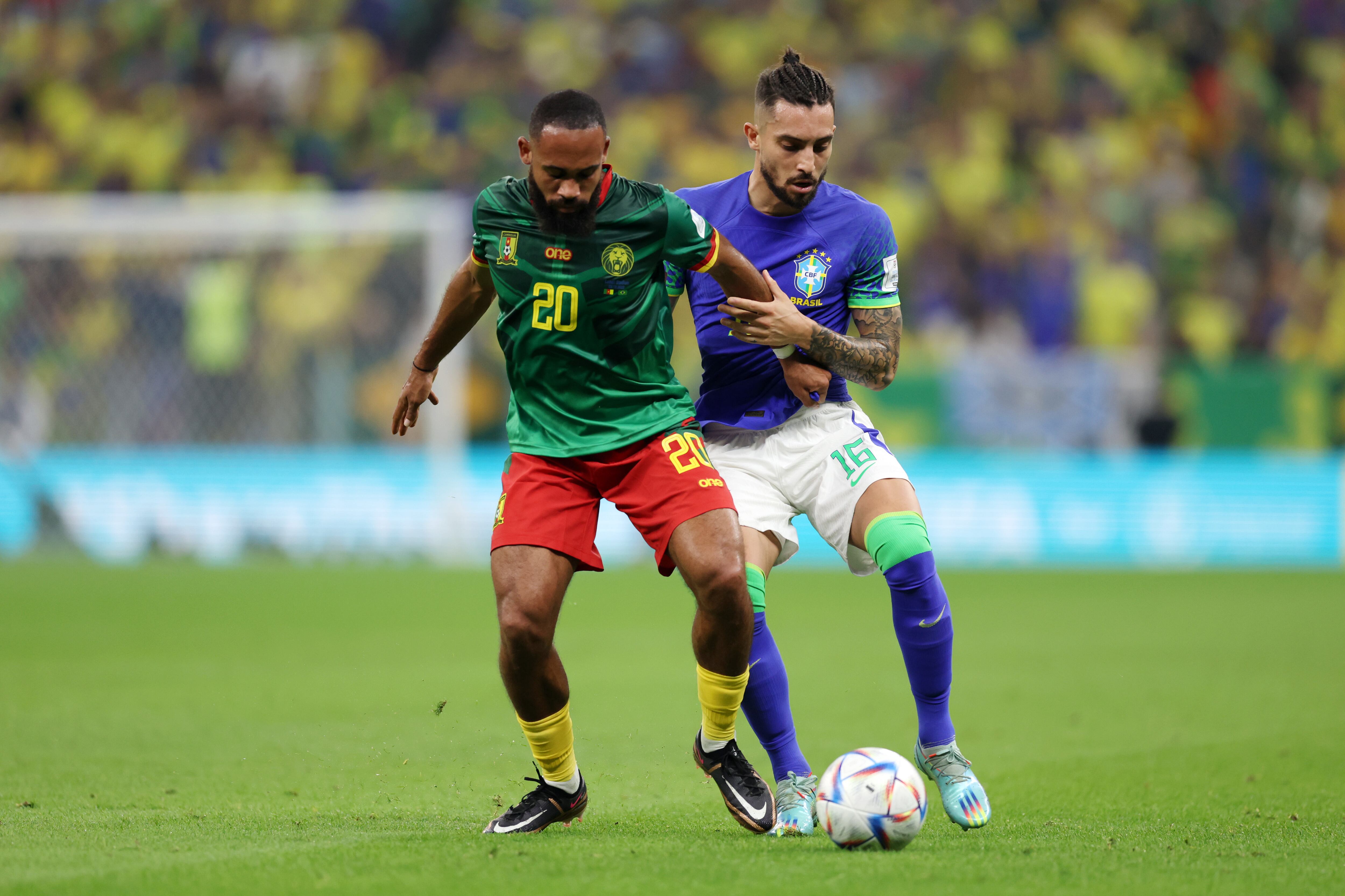 LUSAIL CITY, QATAR - DECEMBER 02: Bryan Mbeumo of Cameroon is challenged by Alex Telles of Brazil during the FIFA World Cup Qatar 2022 Group G match between Cameroon and Brazil at Lusail Stadium on December 02, 2022 in Lusail City, Qatar. (Photo by Clive Brunskill/Getty Images)