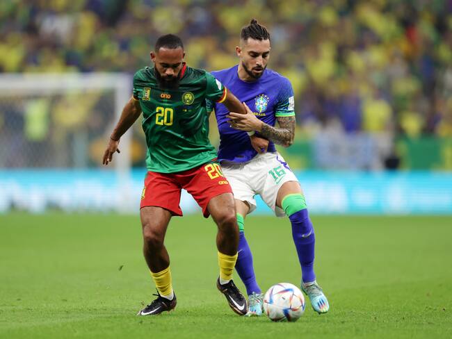 LUSAIL CITY, QATAR - DECEMBER 02: Bryan Mbeumo of Cameroon is challenged by Alex Telles of Brazil during the FIFA World Cup Qatar 2022 Group G match between Cameroon and Brazil at Lusail Stadium on December 02, 2022 in Lusail City, Qatar. (Photo by Clive Brunskill/Getty Images)