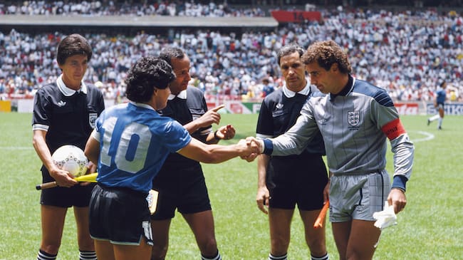 Diego Maradona of Argentina #10 shakes hands with Peter Shilton of England under the watching eye of referee Ali Bin Nasser (c) before the 1986 FIFA World Cup Quarter Final on 22 June 1986 at the Azteca Stadium in Mexico City, Mexico. (Photo by David Cannon/Allsport/Getty Images)