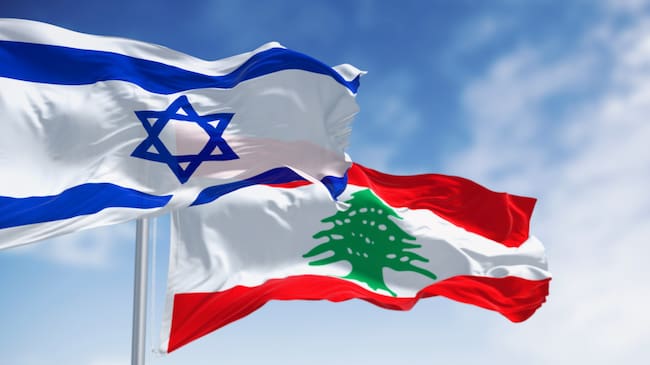 Flags of Israel and Lebanon waving in the wind on a clear day. Geopolitical instability and border security. 3d illustration render. Selective focus
