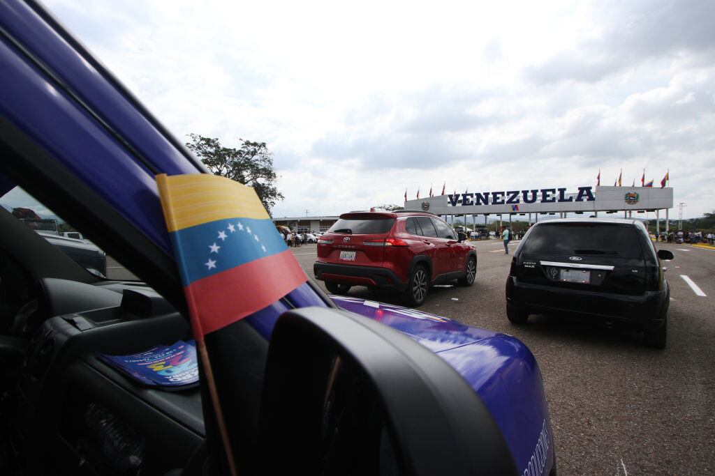 Vehicles are seen waiting to cross the border line during the opening of the international bridge Atanasio Girardot. Tienditas, January 01, 2023. Located between the border crossings of Colombia and Venezuela, the binational infrastructure, renamed the Atanasio Girardot Bridge, was the epicenter of the years of tensions that preceded the reestablishment of relations and will be reopened for the crossing of vehicles, as well as merchandise and people. 240 meters long and 40 meters wide, this bridge has lanes for cargo trucks, cars, pedestrians and bicycles.  (Photo by Jorge Mantilla/NurPhoto via Getty Images)