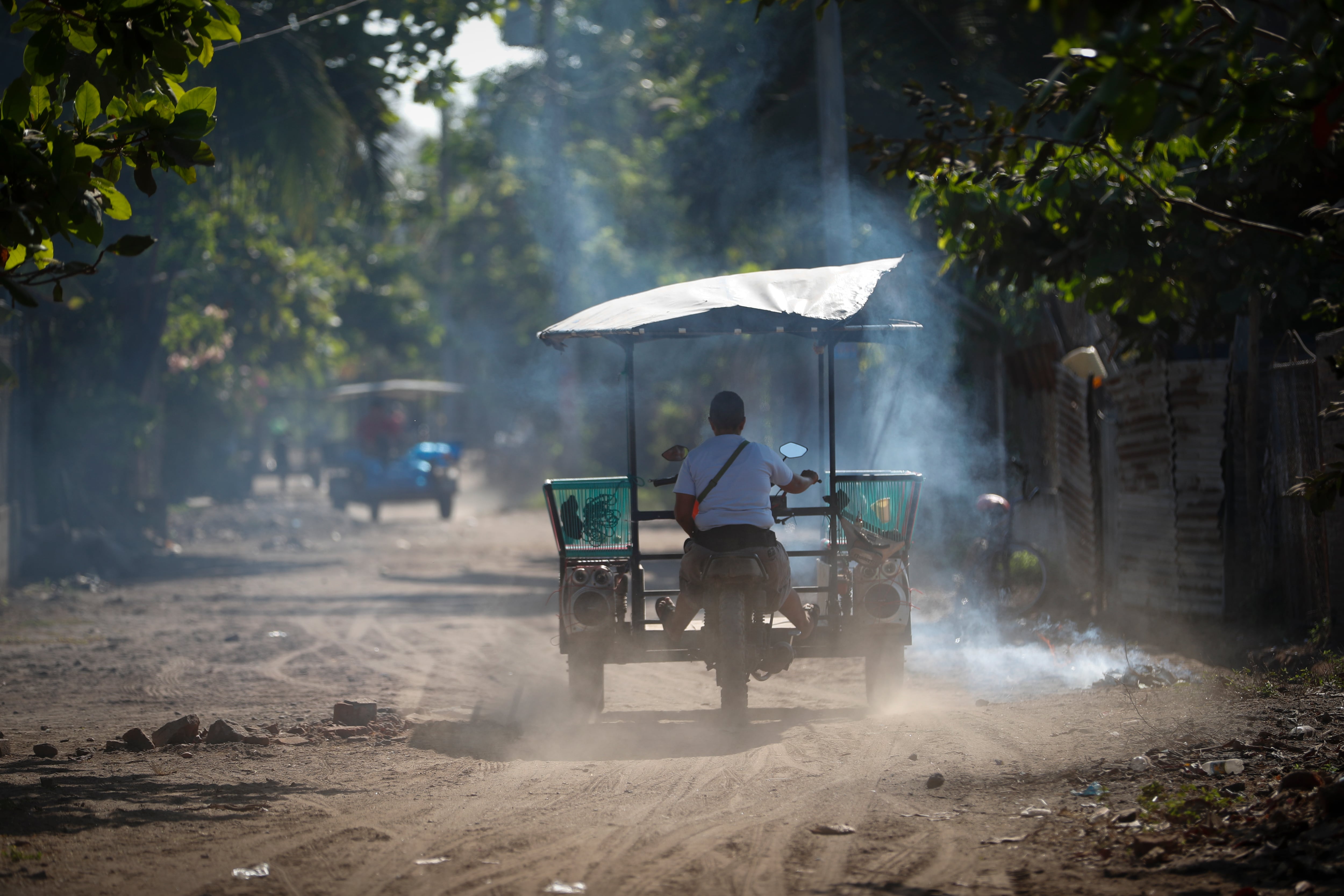 ACOMPAÑA CRÓNICA: EL SALVADOR PANDILLAS - AME8827. ISLA ESPÍRITU SANTO (EL SALVADOR), 13/02/2024.- Sandra Leticia Hernández, de 42 años, maneja su moto-taxi el 5 de febrero de 2024, en la Isla Espíritu Santo (El Salvador). La isla Espíritu Santo era un remanso de paz en un país, El Salvador, donde las pandillas o maras habían impuesto el terror y la violencia con asesinatos y extorsiones. Pero llegó el régimen de excepción del presidente Nayib Bukele para luchar contra esas agrupaciones, y de pronto una serie de llamadas y acusaciones "falsas" empujó a una veintena de isleños a la cárcel por "colaboradores". EFE/ Bienvenido Velasco