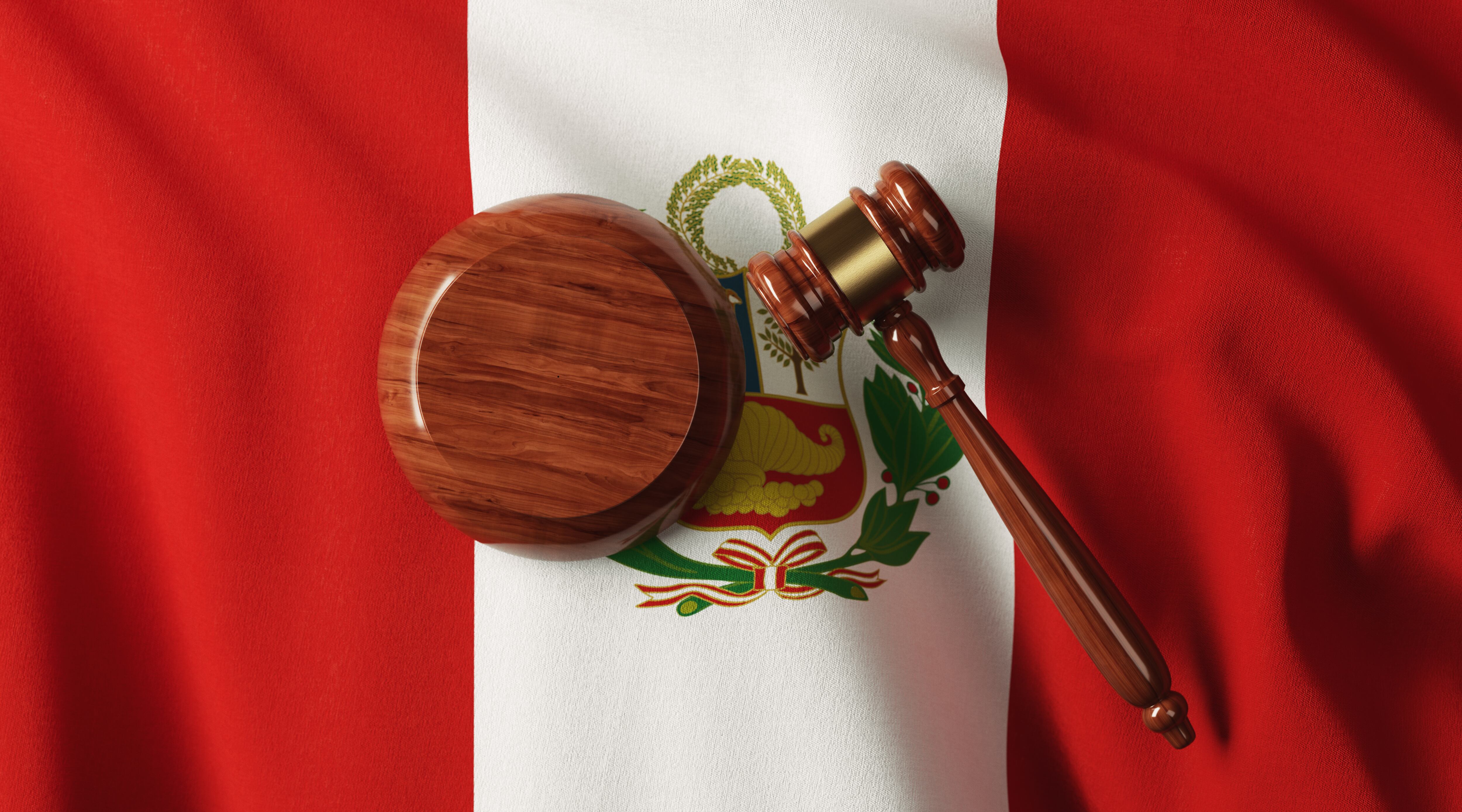 Wooden gavel on Peruvian flag.  Horizontal composition with copy space.