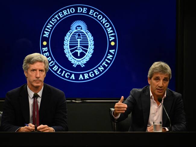 Economy Minister Luis Caputo (R), accompanied by the President of the Central Bank of Argentina Santiago Bausili (L), speaks during a press conference about the agreement made between Argentina and the International Monetary Fund, at the Economy Ministry headquarters in Buenos Aires on January 10, 2024. Argentina and the IMF announced this Wednesday an agreement at a technical level, subject to the approval of the organization's board of directors, for the disbursement of 4.7 billion dollars to the South American country within the framework of its credit program with the financial institution. (Photo by Luis ROBAYO / AFP) (Photo by LUIS ROBAYO/AFP via Getty Images)