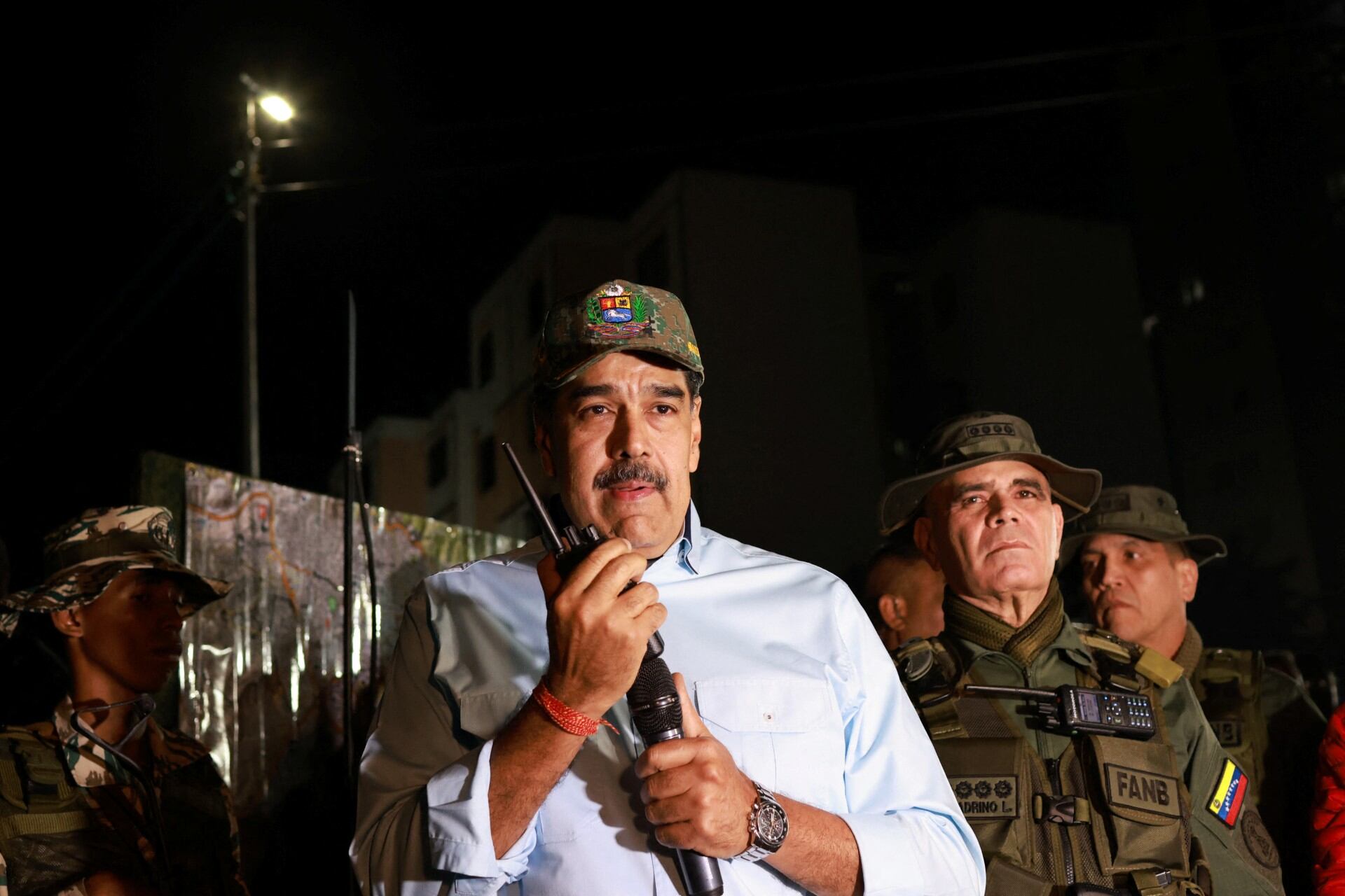 This handout picture released by the Venezuelan Presidency press office shows Venezuela's President Nicolas Maduro (L) speaking next to Venezuela's Defense Minister Vladimir Padrino (R) during a military deployment in Caribia town, outskirts of Caracas, on September 11, 2025. (Photo by Marcelo Garcia / Venezuelan Presidency / AFP) / RESTRICTED TO EDITORIAL USE - MANDATORY CREDIT "AFP PHOTO / VENEZUELAN PRESIDENCY / MARCELO GARCIA" - HANDOUT - NO MARKETING NO ADVERTISING CAMPAIGNS - DISTRIBUTED AS A SERVICE TO CLIENTS - AFP CANNOT INDEPENDENTLY VERIFY THE AUTHENTICITY OR LOCATION, DATE, AND CONTENT OF THESE IMAGES. /