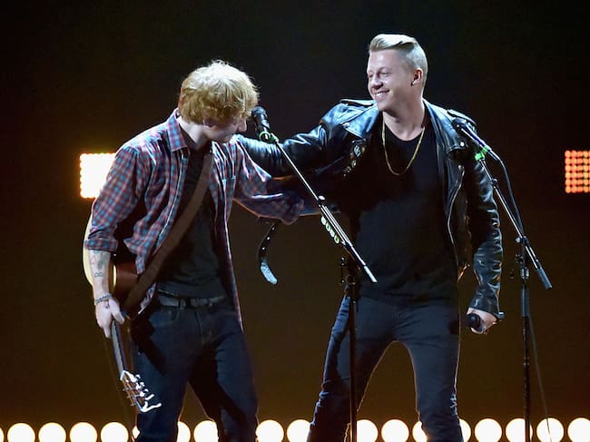 LAS VEGAS, NV - SEPTEMBER 20: Recording artists Ed Sheeran (L) and Macklemore perform ontage during the 2014 iHeartRadio Music Festival at the MGM Grand Garden Arena on September 20, 2014 in Las Vegas, Nevada. (Photo by Jeff Kravitz/FilmMagic)