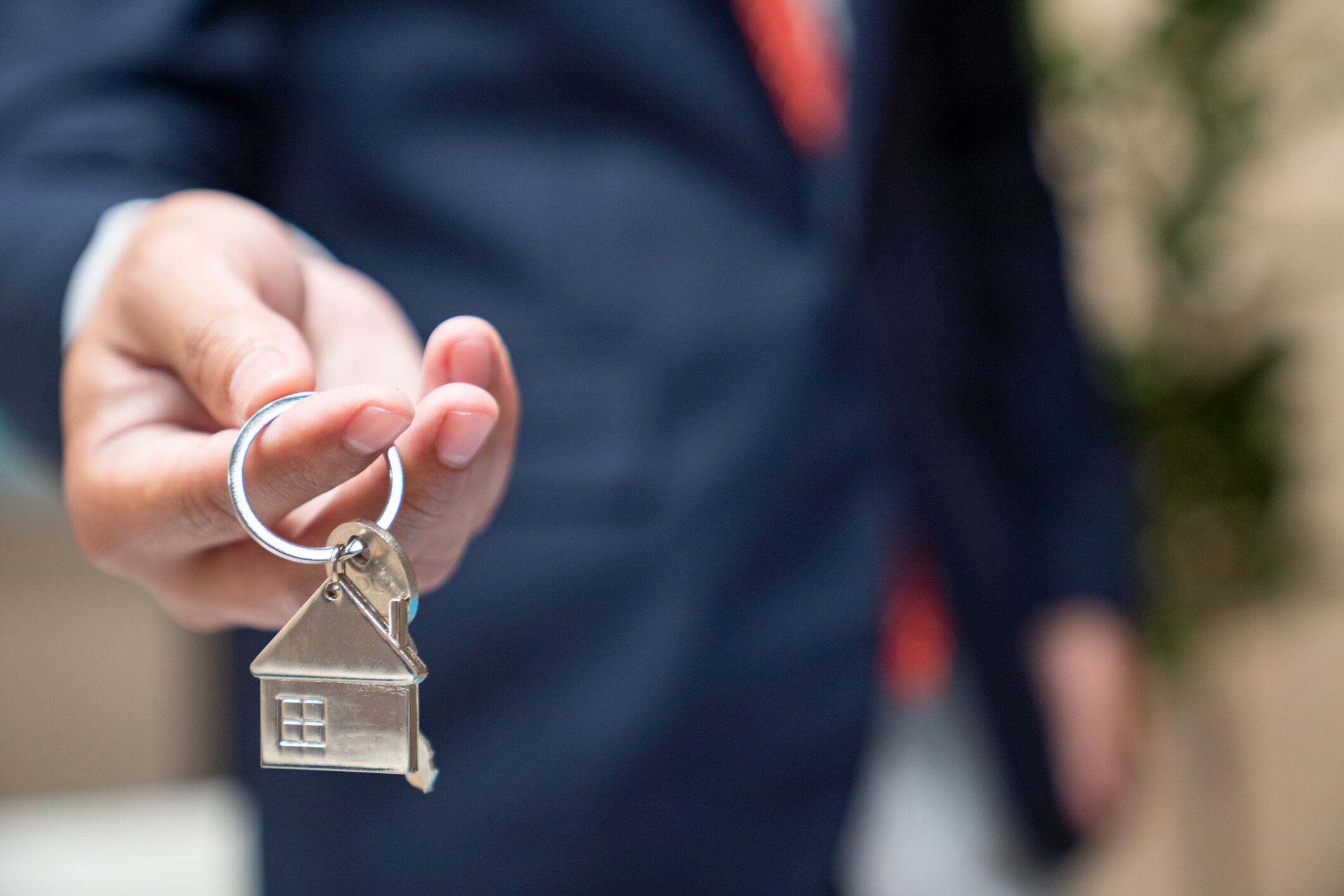 hand holding house key,real estate agent