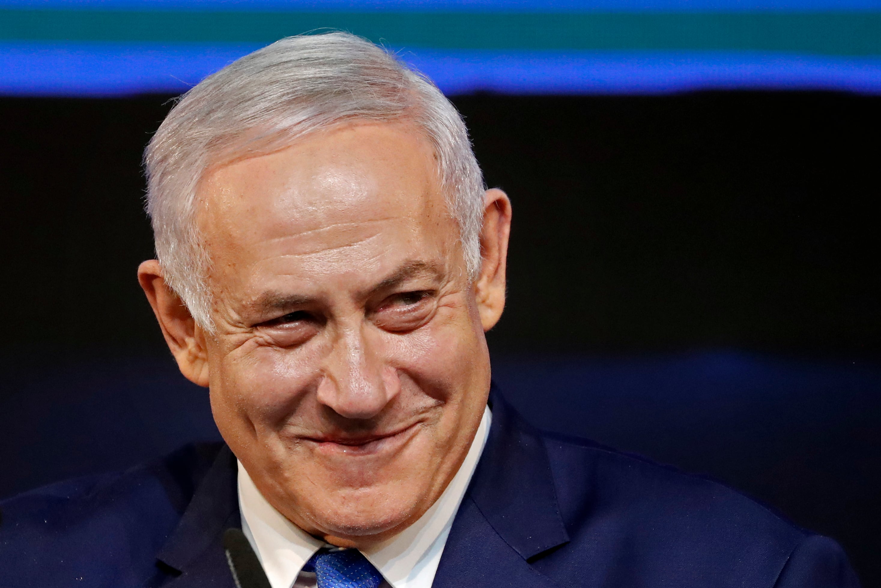 Israeli Prime Minister Benjamin Netanyahu smiles as he addresses supporters on election night at his Likud Party headquarters in the Israeli coastal city of Tel Aviv early on April 10, 2019. - The results from yesterday's vote came despite corruption allegations against the 69-year-old premier and put him on track to become Israel's longest-serving prime minister later this year. (Photo by THOMAS COEX / AFP) (Photo by THOMAS COEX/AFP via Getty Images)