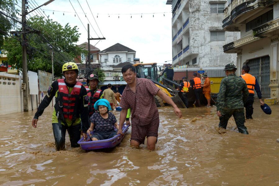 Rescue workers help a stranded woman from a flooded area at the border town of Mae Sai, following the impact of Typhoon Yagi, in the northern province of Chiang Rai, Thailand, September 12, 2024. REUTERS/SZZW