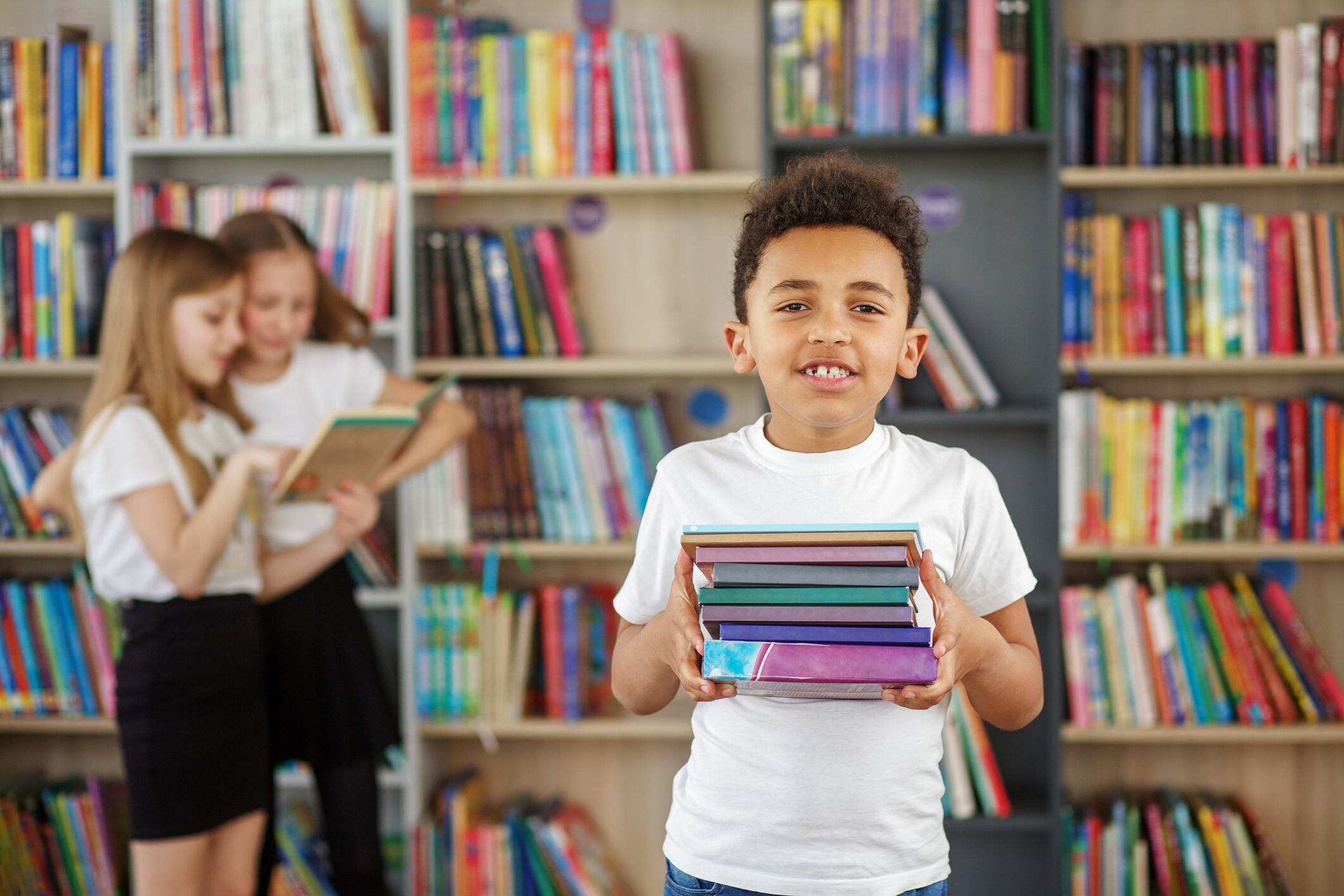 Concept of studying, back to school and education. Child schoolboy reading book in library or bookstore.