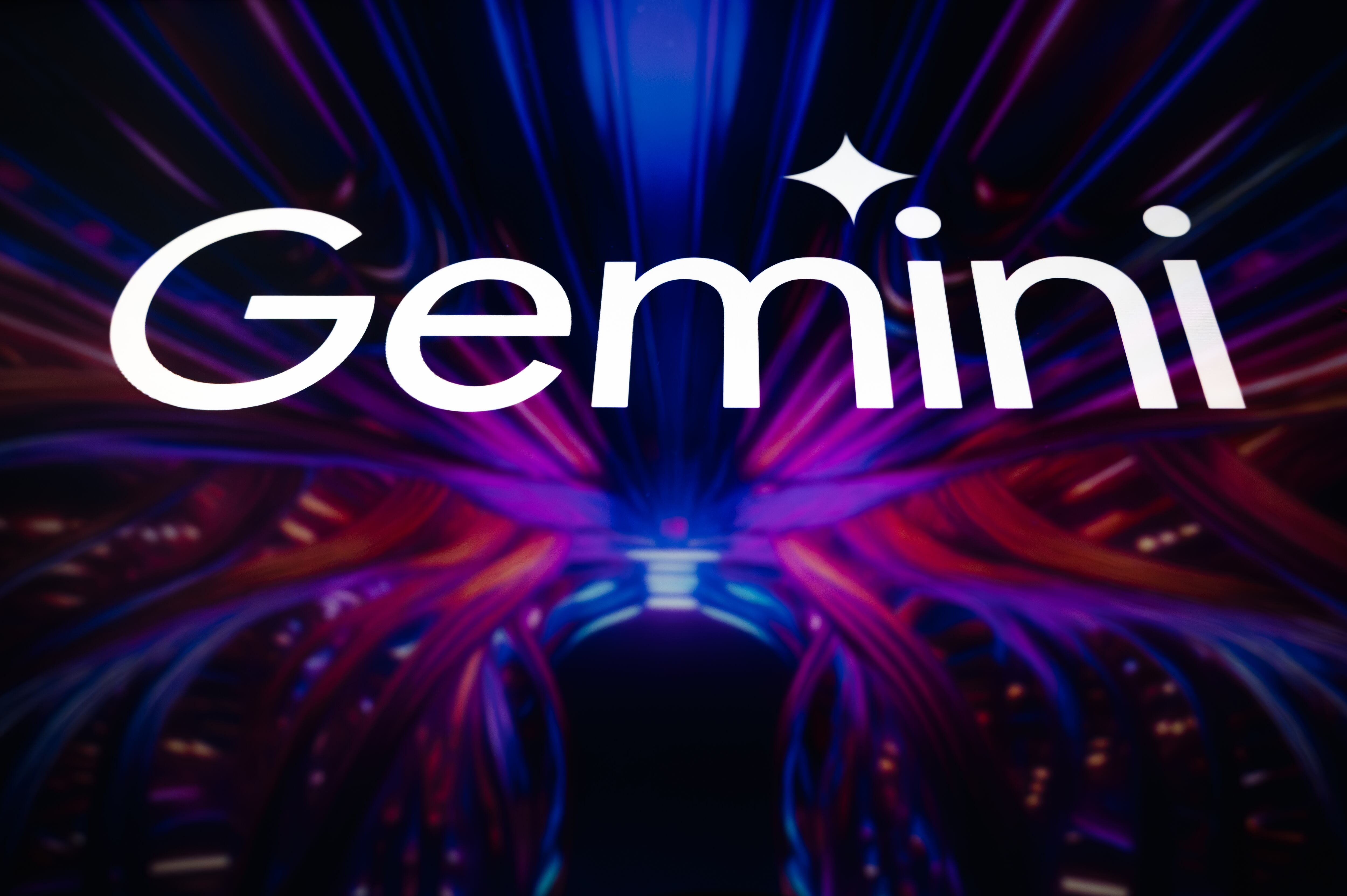 This illustration shows the logo of Google's artificial intelligence (AI) application, Gemini, displayed on the screen of a tablet, which reflects a colorful illustration related to the technological flow field, in Paris, France, on February 6, 2025. (Photo by Samuel Boivin/NurPhoto via Getty Images)