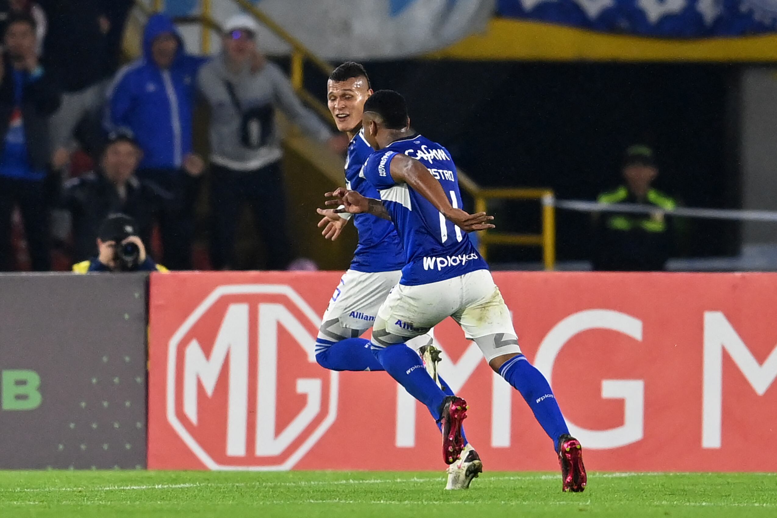 Millonarios' forward Luis Paredes (back) celebrates with midfielder Beckham Castro after scoring a goal during the Copa Sudamericana group stage second leg football match between Colombia's Millonarios and Uruguay's Peñarol at the Nemesio Camacho "El Campín" stadium in Bogota, on May 23, 2023. (Photo by Juan BARRETO / AFP) (Photo by JUAN BARRETO/AFP via Getty Images)