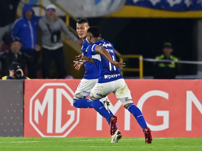 Millonarios' forward Luis Paredes (back) celebrates with midfielder Beckham Castro after scoring a goal during the Copa Sudamericana group stage second leg football match between Colombia's Millonarios and Uruguay's Peñarol at the Nemesio Camacho "El Campín" stadium in Bogota, on May 23, 2023. (Photo by Juan BARRETO / AFP) (Photo by JUAN BARRETO/AFP via Getty Images)