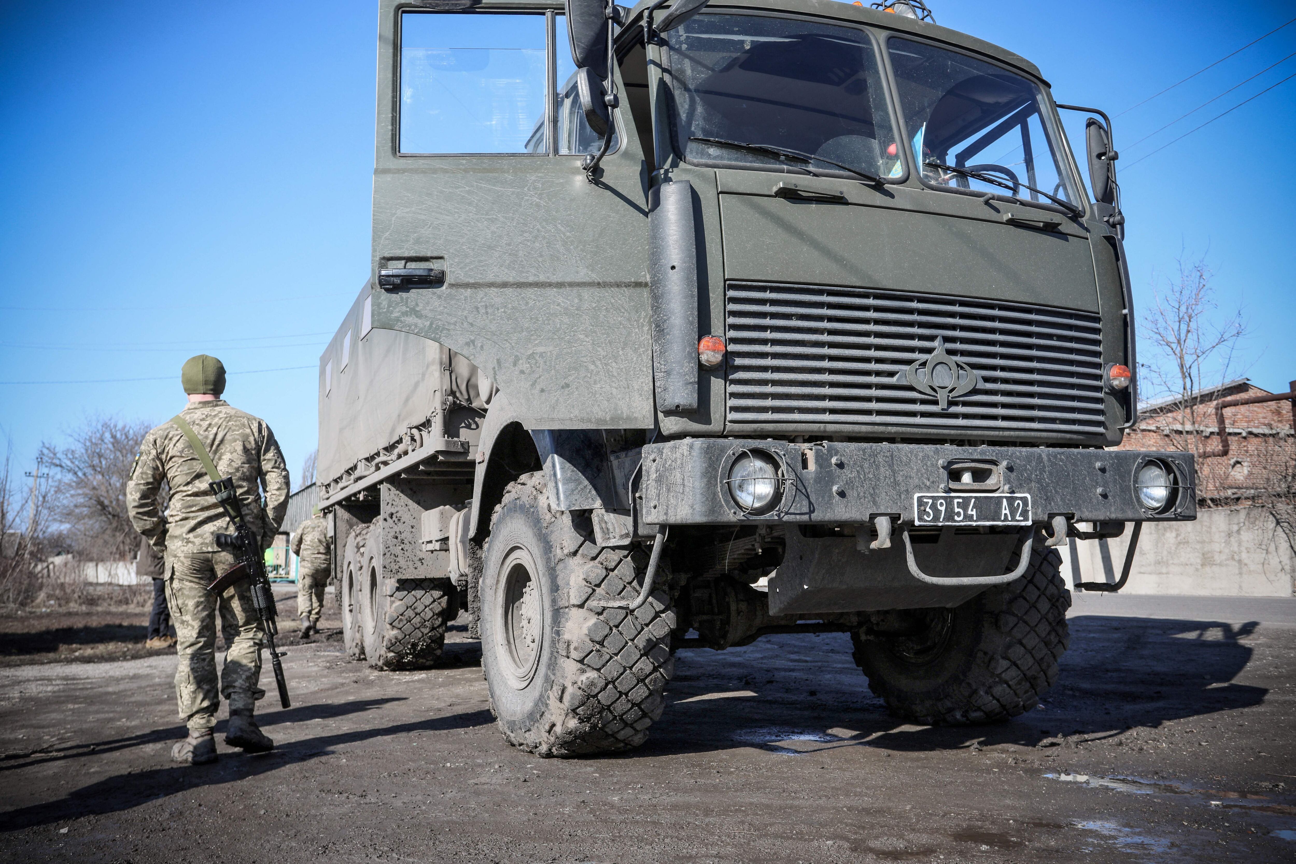 A Ukrainian Military Forces serviceman walks past a military vehicle in the Donetsk region town of Avdiivka, on the eastern Ukraine front-line with Russia-backed separatists on February 21, 2022. - The rebel leaders of east Ukraine's two self-proclaimed republics asked Russian President to recognise the independence of their breakaway territories in a coordinated appeal on February 21. (Photo by Aleksey Filippov / AFP) (Photo by ALEKSEY FILIPPOV/AFP via Getty Images)