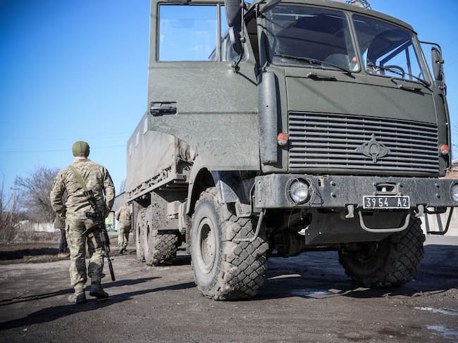 A Ukrainian Military Forces serviceman walks past a military vehicle in the Donetsk region town of Avdiivka, on the eastern Ukraine front-line with Russia-backed separatists on February 21, 2022. - The rebel leaders of east Ukraine's two self-proclaimed republics asked Russian President to recognise the independence of their breakaway territories in a coordinated appeal on February 21. (Photo by Aleksey Filippov / AFP) (Photo by ALEKSEY FILIPPOV/AFP via Getty Images)