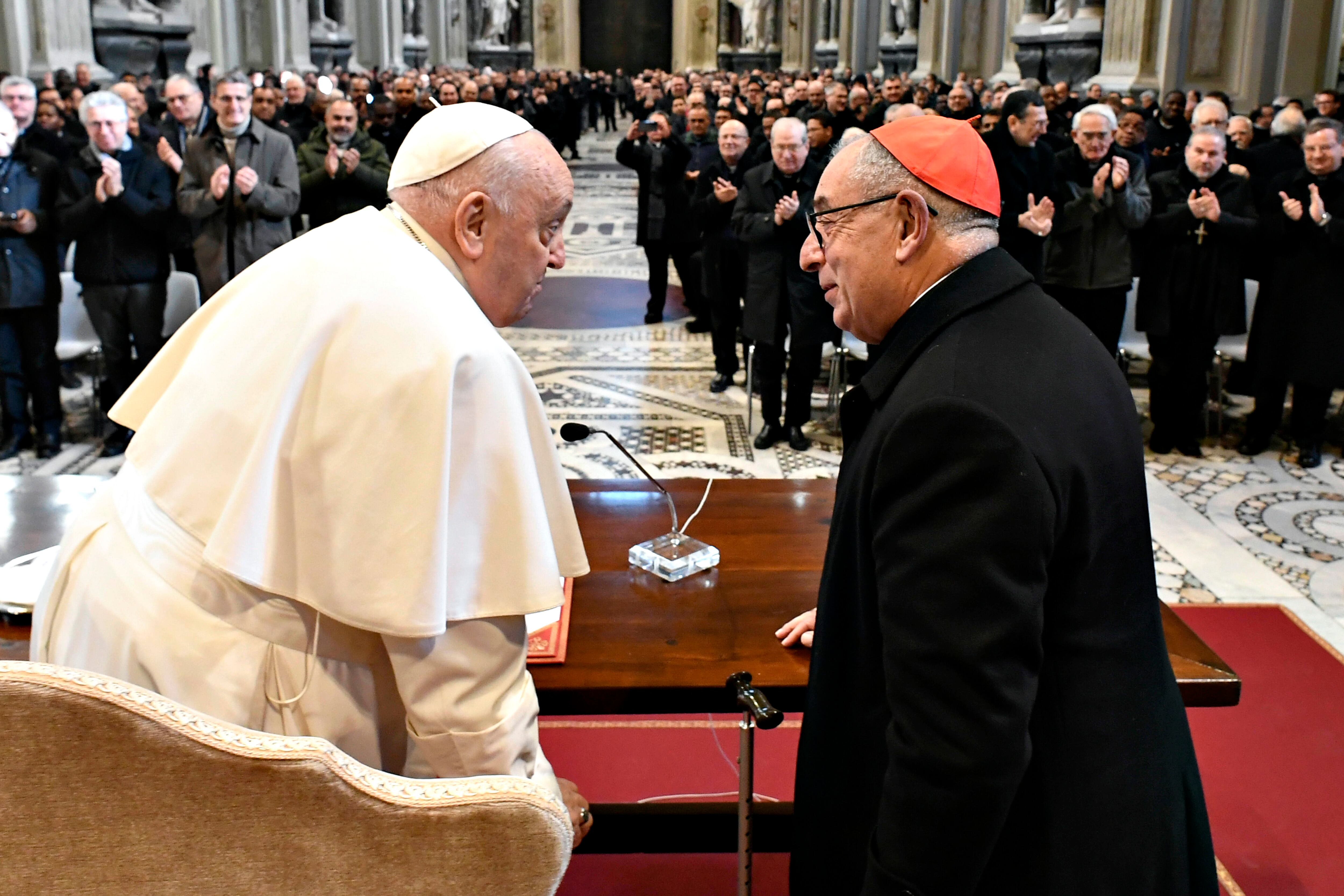 VATICAN CITY, VATICAN - JANUARY 13: (EDITOR NOTE: STRICTLY EDITORIAL USE ONLY - NO MERCHANDISING) Pope Francis, flanked by the Diocesan Vicar Cardinal Angelo De Donatis,   meets with over 800 priests of the Diocese of Rome in the Basilica of St. John Lateran on January 13, 2024 in Vatican City, Vatican. To the over 800 priests, diocesans, religious, and permanent deacons serving the Diocese, Pope Francis, the Bishop of Rome, launched an appeal for the evangelization of the entire ecclesiastical community. (Photo by Vatican Media via Vatican Pool/Getty Images)