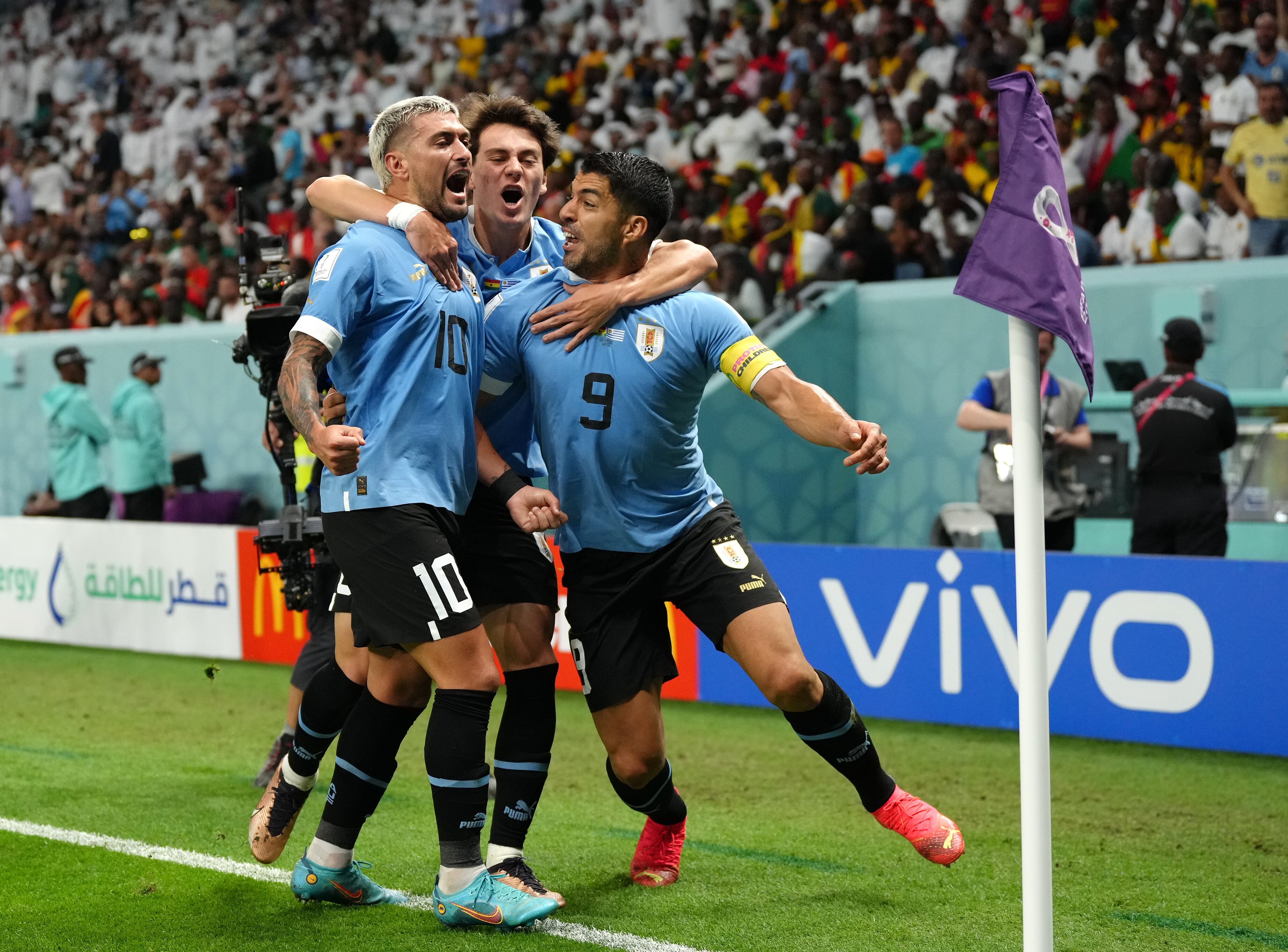 Uruguay's Giorgian de Arrascaeta celebrates scoring their side's first goal of the game with teammate Luis Suarez during the FIFA World Cup Group H match at the Al Janoub Stadium in Al-Wakrah, Qatar. Picture date: Friday December 2, 2022. (Photo by Nick Potts/PA Images via Getty Images)