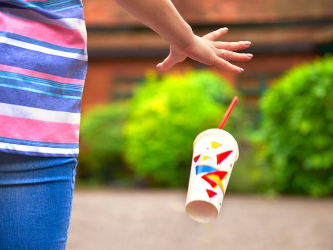 Persona botando basura en otra propiedad / cortesía Getty
