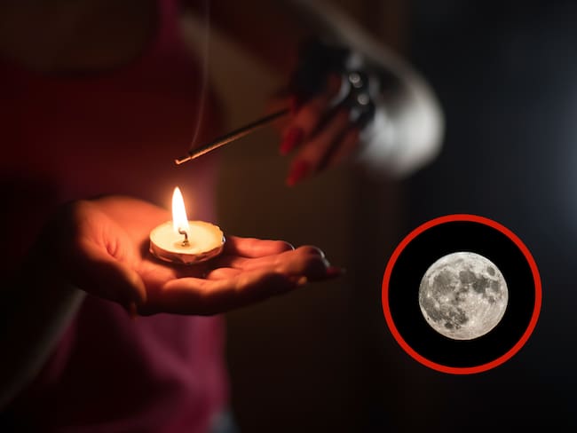 Persona sosteniendo una vela junto a una luna llena (Foto vía Getty Images)