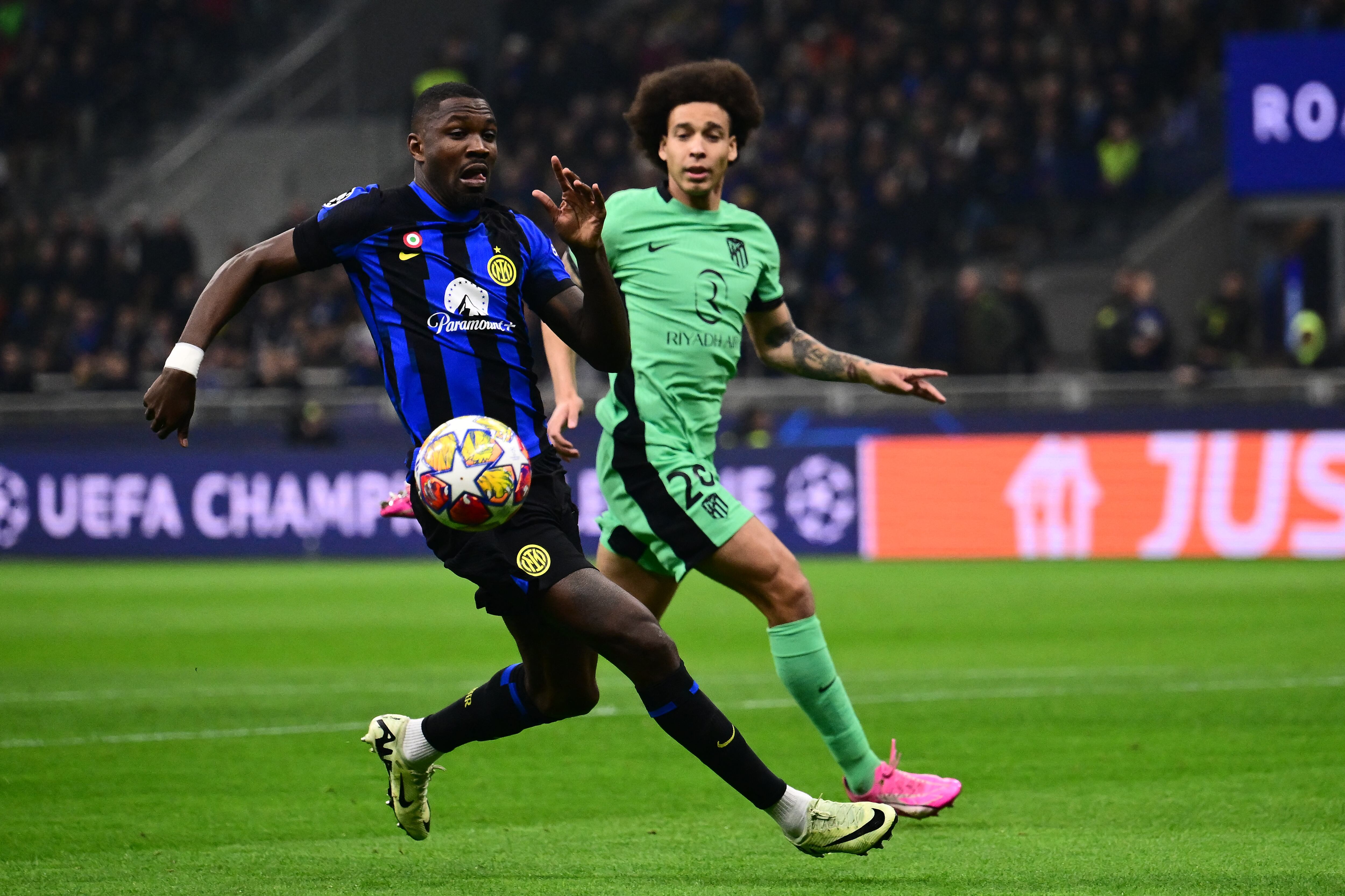 Inter Milan's French forward #09 Marcus Thuram fights for the ball with Atletico Madrid's Belgian midfielder #20 Axel Witsel during the UEFA Champions League last 16 first leg football match Inter Milan vs Atletico Madrid at the San Siro stadium in Milan on February 20, 2024. (Photo by Marco BERTORELLO / AFP) (Photo by MARCO BERTORELLO/AFP via Getty Images)
