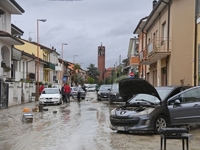 Local residents observe the aftermath of a flooding in a street of the San Rocco district of Cesena on May 17, 2023. Heavy rains have caused major floodings in central Italy, where trains were stopped and schools were closed in many towns while people were asked to leave the ground floors of their homes and to avoid going out. Five people have died after the floodings across Italy&#039;s northern Emilia Romagna region, a local official said. (Photo by Alessandro SERRANO / AFP) (Photo by ALESSANDRO SERRANO/AFP via Getty Images)