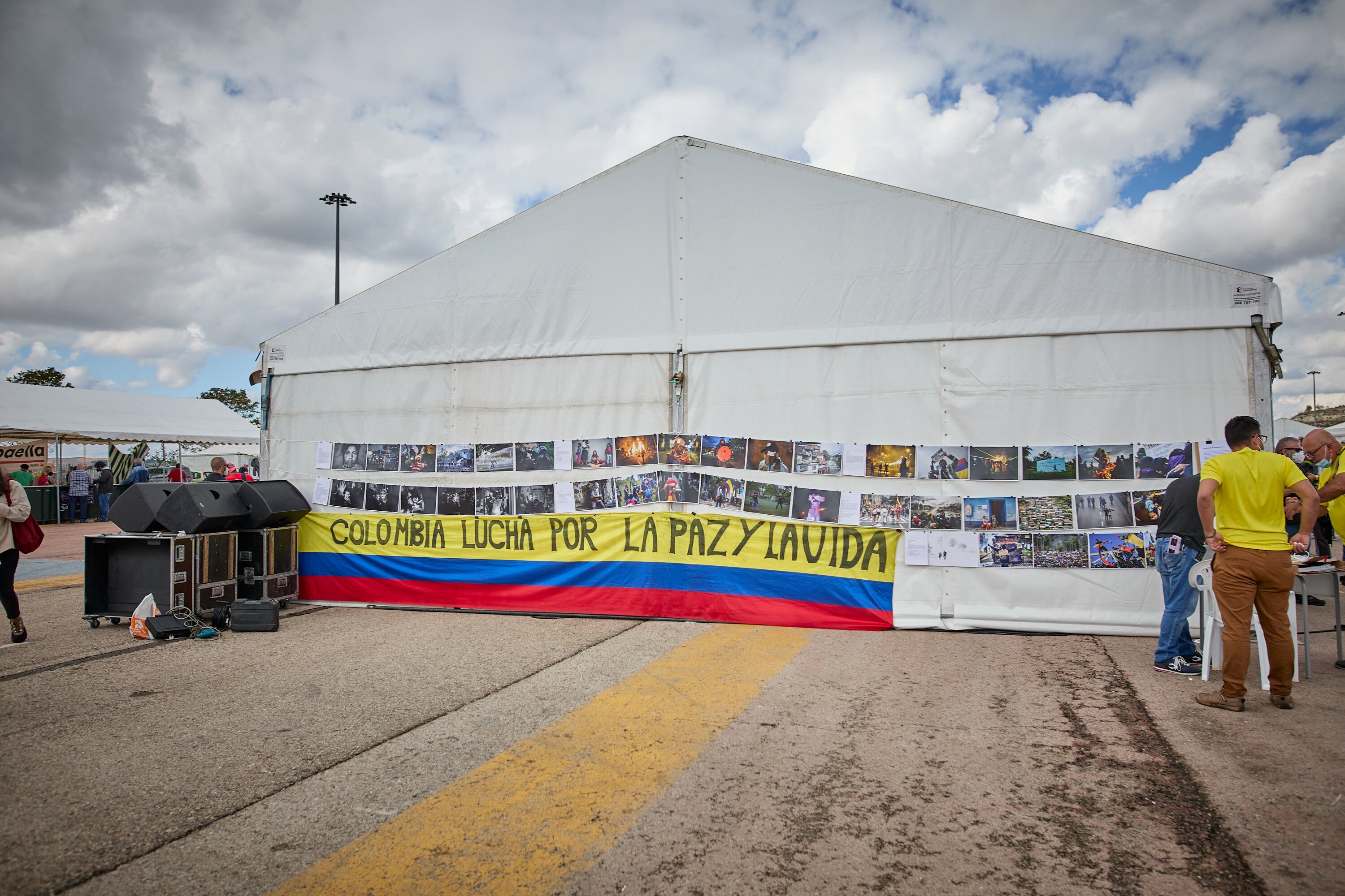 MADRID, SPAIN - SEPTEMBER 25: A flag of Colombia next to several photos of the South American country, at the centenary party of the PCE, on 25 September, 2021 in Rivas-Vaciamadrid, Madrid, Spain. The annual party of the PCE, commemorates in this edition the centenary of the formation. One of the central issues to be discussed at this event is the popular unity of the forces of the left. The debates and conferences set for this weekend will be attended by heavyweights of Unidas Podemos, many of them currently in government. In addition, the program includes concerts by bands like Mafalda, Los Chikos del Maiz or singer-songwriters like Silvio Rodriguez. (Photo By Jesus Hellin/Europa Press via Getty Images)