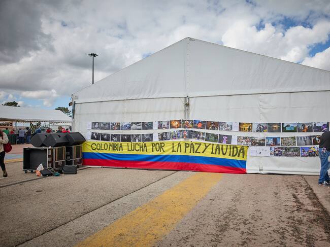 MADRID, SPAIN - SEPTEMBER 25: A flag of Colombia next to several photos of the South American country, at the centenary party of the PCE, on 25 September, 2021 in Rivas-Vaciamadrid, Madrid, Spain. The annual party of the PCE, commemorates in this edition the centenary of the formation. One of the central issues to be discussed at this event is the popular unity of the forces of the left. The debates and conferences set for this weekend will be attended by heavyweights of Unidas Podemos, many of them currently in government. In addition, the program includes concerts by bands like Mafalda, Los Chikos del Maiz or singer-songwriters like Silvio Rodriguez. (Photo By Jesus Hellin/Europa Press via Getty Images)