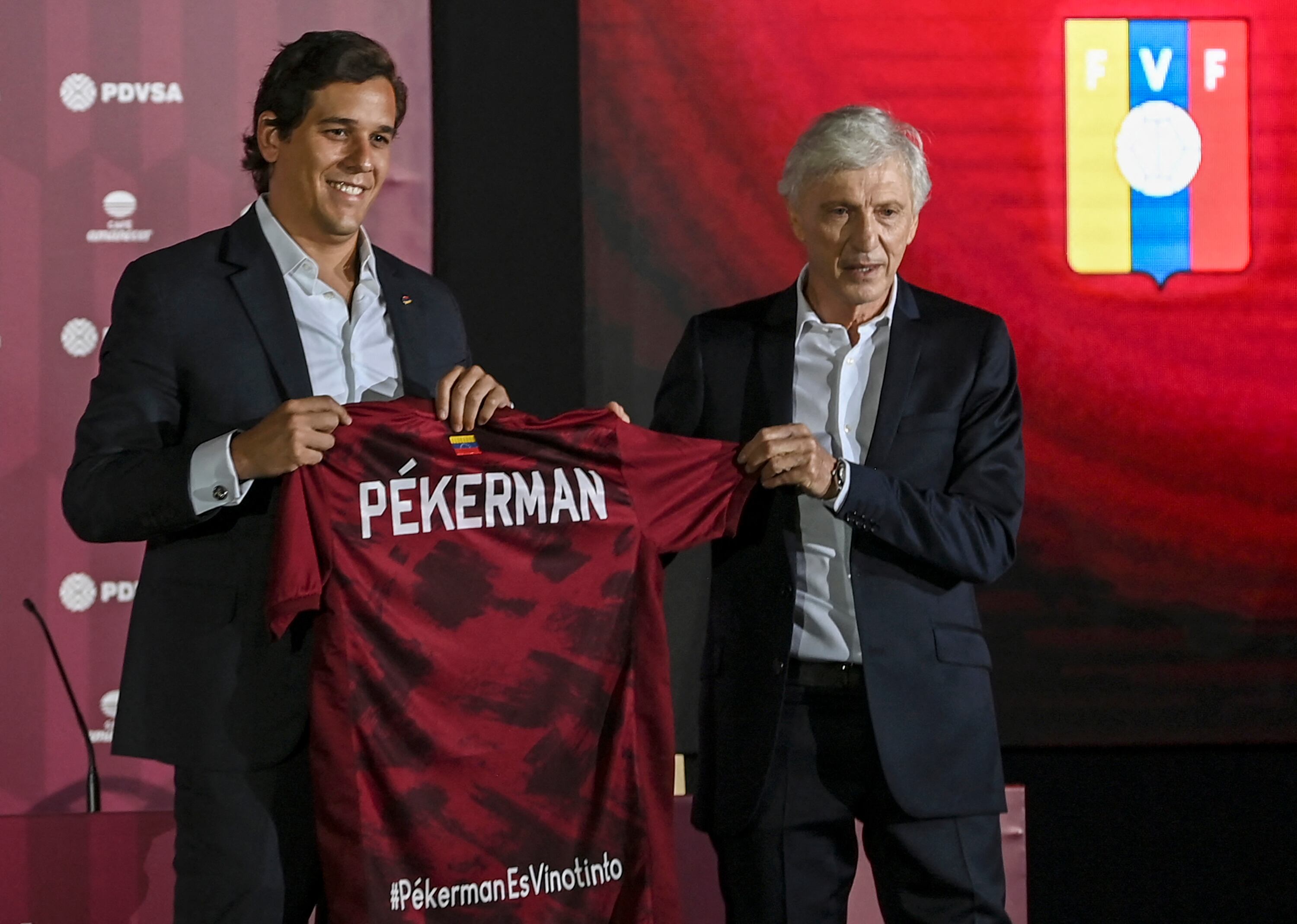 Argentine Jose Nestor Pekerman (R) receives the jersey of the Venezuelan national football team from the president of the Venezuelan Football Federation Jorge Gimenez, after being presented as the squad's new coach, in Caracas on November 30, 2021. (Photo by Yuri CORTEZ / AFP) (Photo by YURI CORTEZ/AFP via Getty Images)