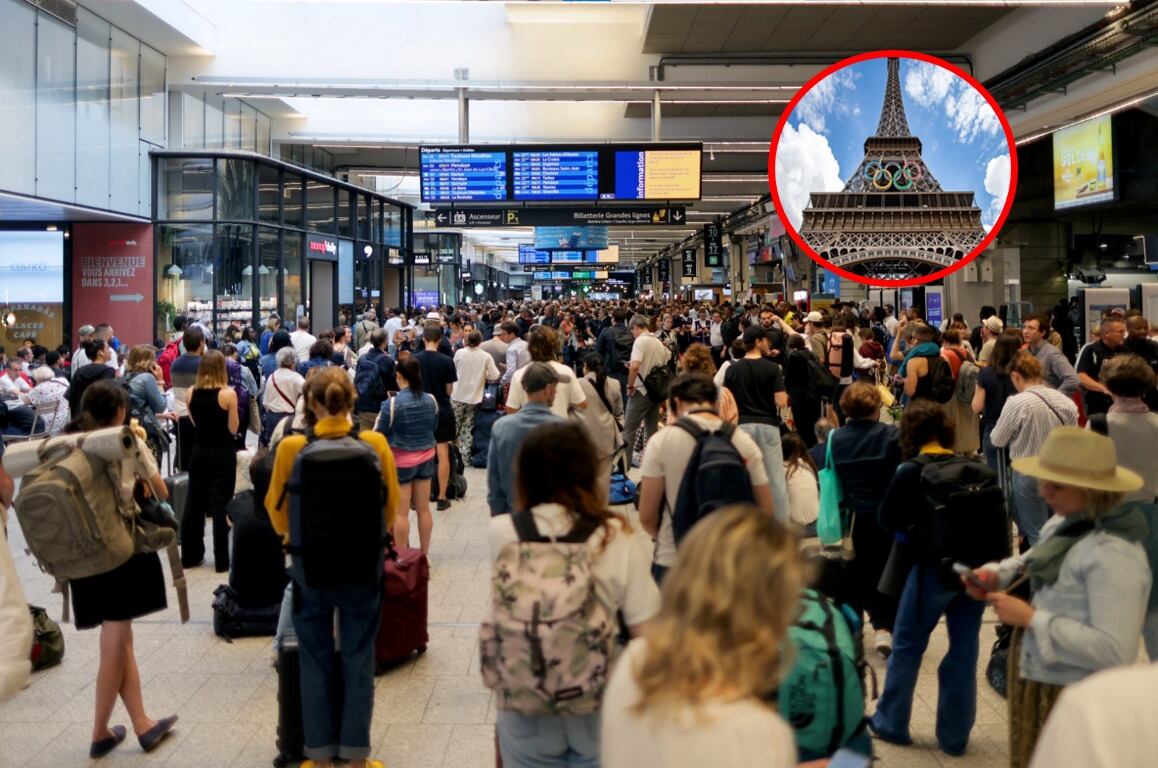 Passengers gather around the departure boards at the Gare Montparnasse train station in Paris on July 26, 2024 as France's high-speed rail network was hit by malicious acts disrupting the transport system hours before the opening ceremony of the Paris 2024 Olympic Games.