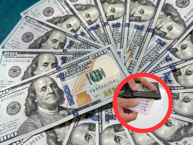 Dólares y billetera con pesos colombianos (Getty Images)