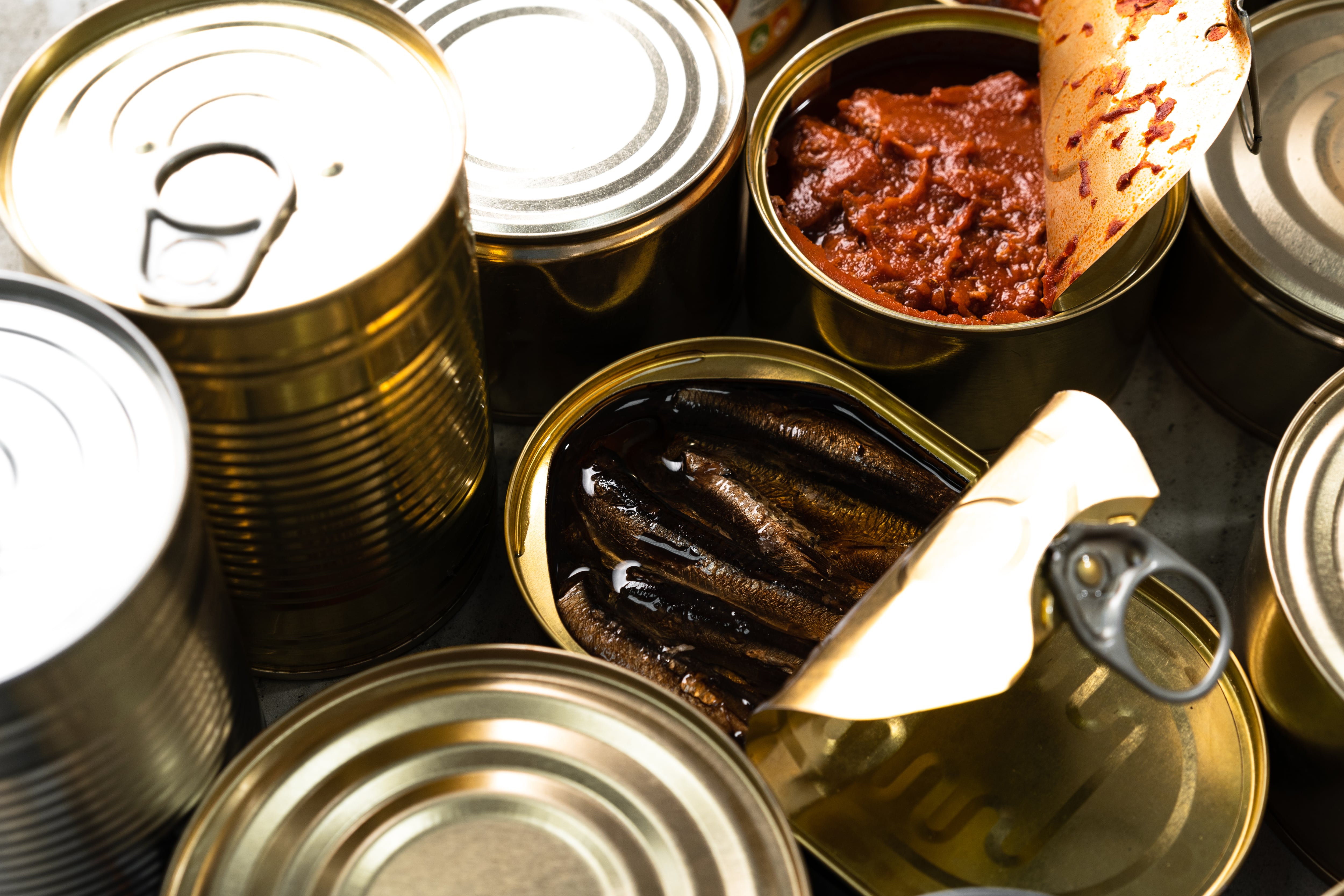 Varios enlatados, dos abiertos al lado de unos cerrados. (Foto: Getty Images)