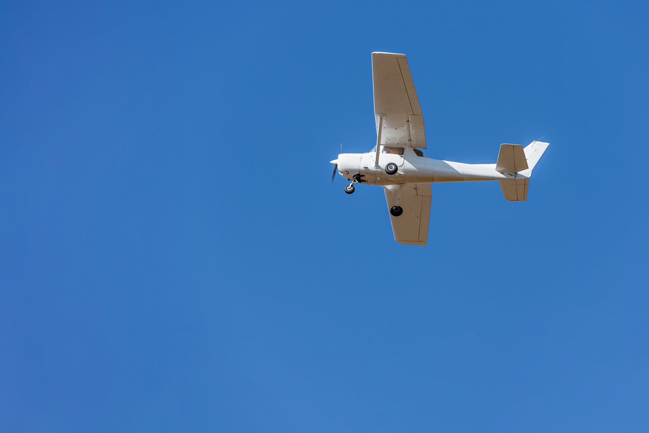 A private plane flying isolated on blue sky