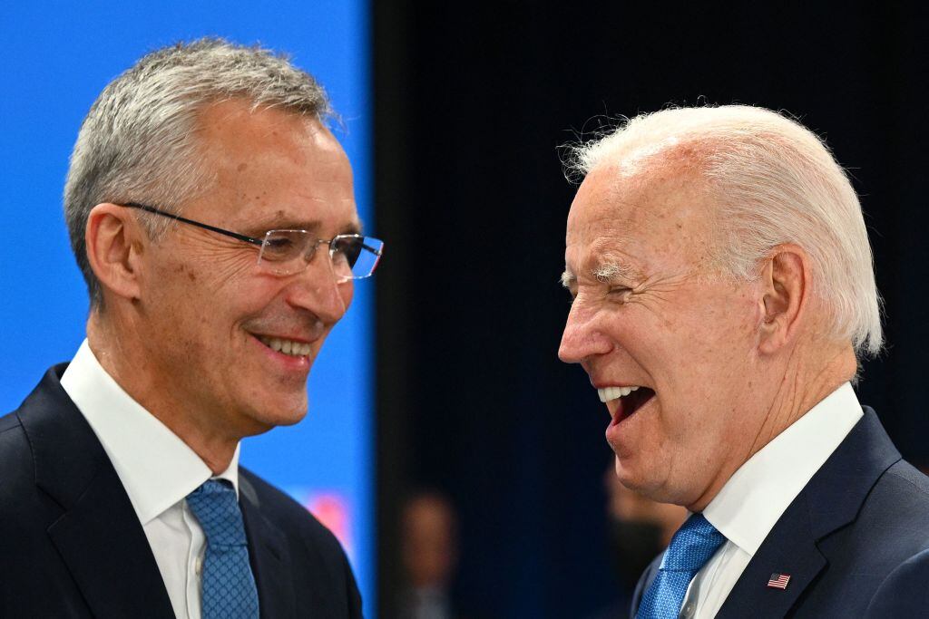 NATO Secretary General Jens Stoltenberg (L) and US President Joe Biden laugh at the start of the second plenary session of the NATO summit at the Ifema congress centre in Madrid, on June 29, 2022. (Photo by GABRIEL BOUYS / AFP) (Photo by GABRIEL BOUYS/AFP via Getty Images)