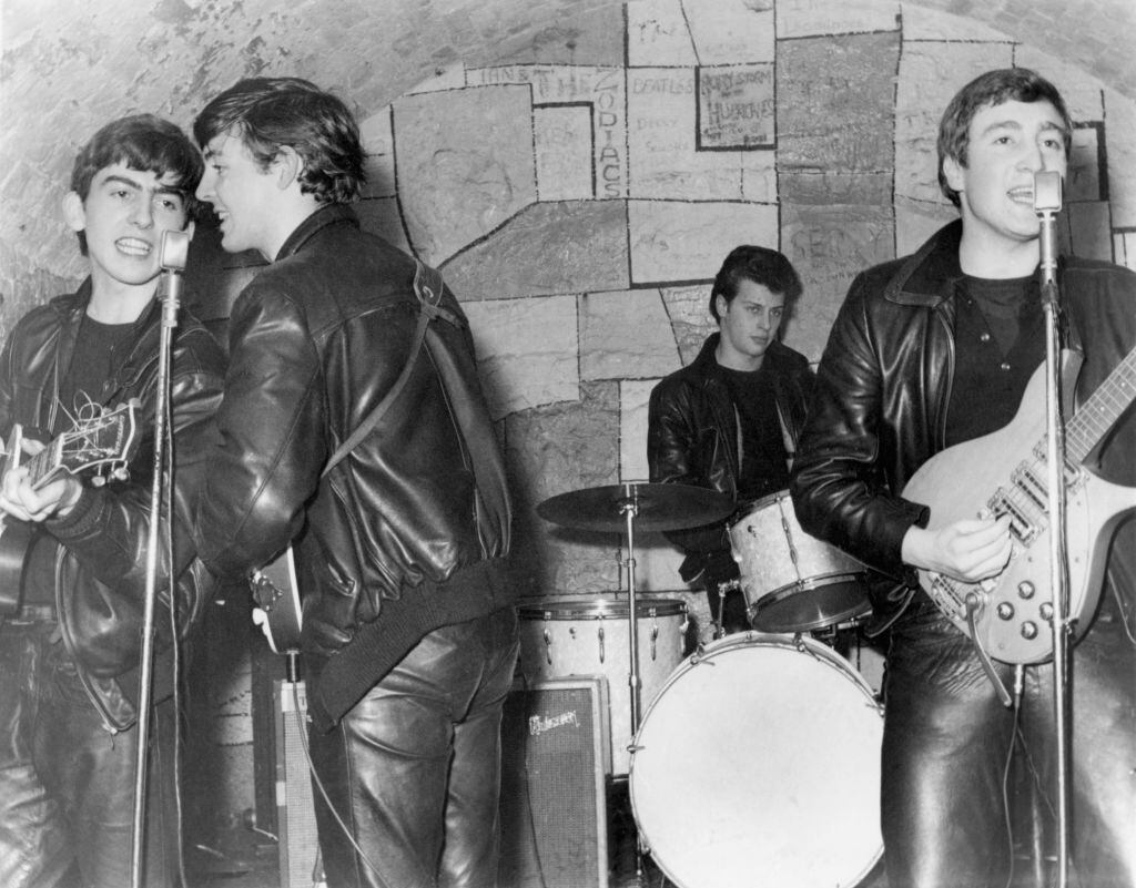 LIVERPOOL - FEBRUARY 1961:  Rock and roll band "The Beatles" performs onstage at the Cavern Club in February 1961 in Liverpool, England. (L-R) George Harrison, Paul McCartney, Pete Best, John Lennon. (Photo by Michael Ochs Archives/Getty Images)