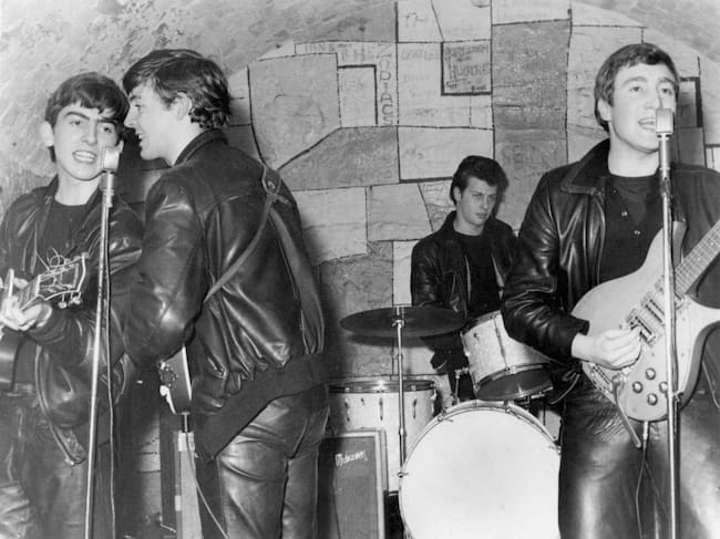 LIVERPOOL - FEBRUARY 1961: Rock and roll band "The Beatles" performs onstage at the Cavern Club in February 1961 in Liverpool, England. (L-R) George Harrison, Paul McCartney, Pete Best, John Lennon. (Photo by Michael Ochs Archives/Getty Images)