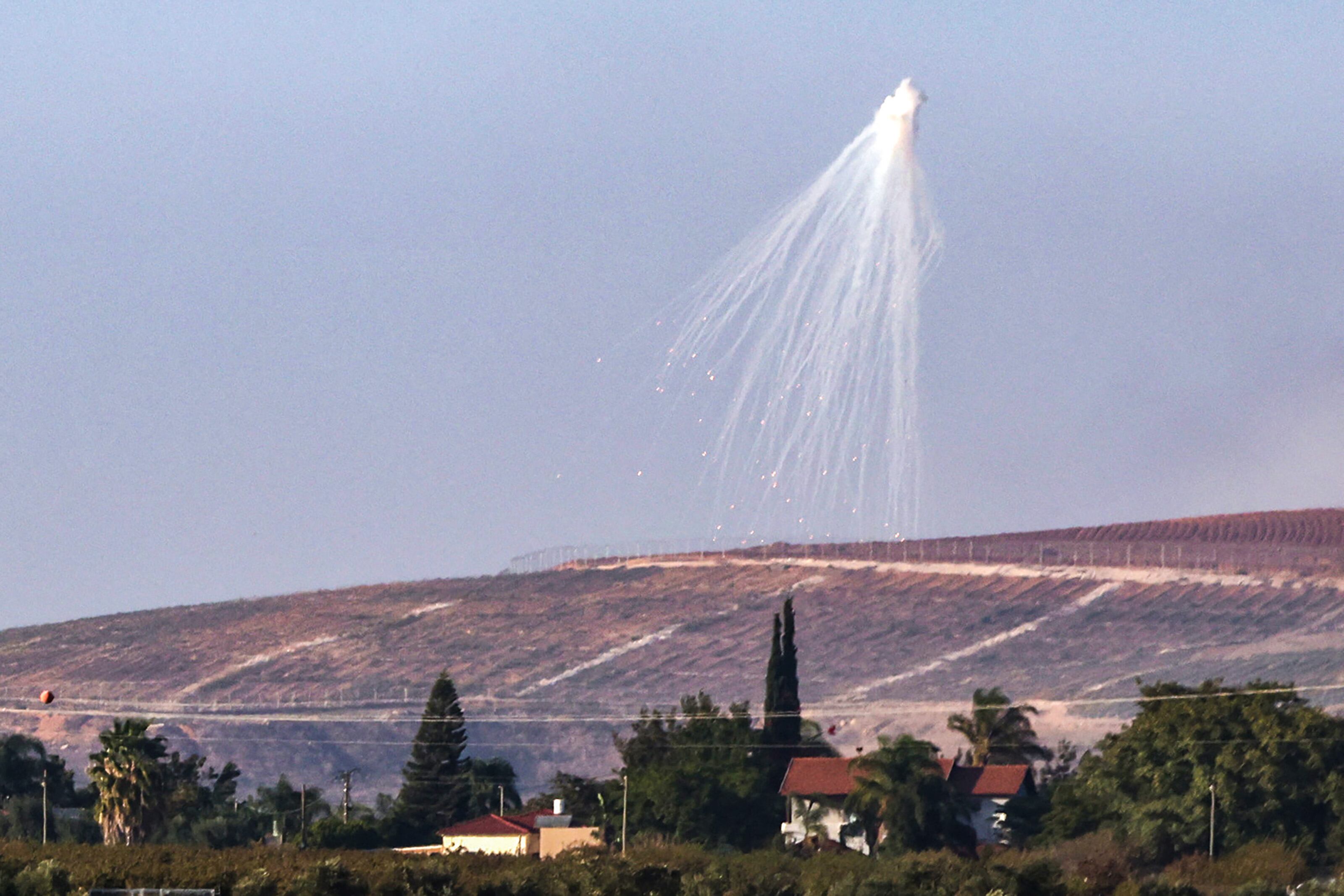 This picture taken from the moshav Kfar Yuval in northern Israel shows a shell fired by Israeli troops, exploding over hills in southern Lebanon on November 9, 2023. Since the day after the October 7 attack by the Hamas goup, Israel has traded fire across its northern border on a near-daily basis with Hamas's ally Hezbollah and other Palestinian militants in Lebanon. (Photo by jalaa marey / AFP) (Photo by JALAA MAREY/AFP via Getty Images)