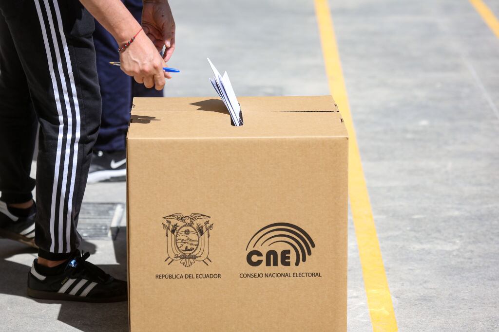 Voters wearing protective masks cast ballots at polling station during the first round of presidential elections in Quito, Ecuador, on February 7, 2021. (Photo by Rafael Rodriguez/NurPhoto via Getty Images)
