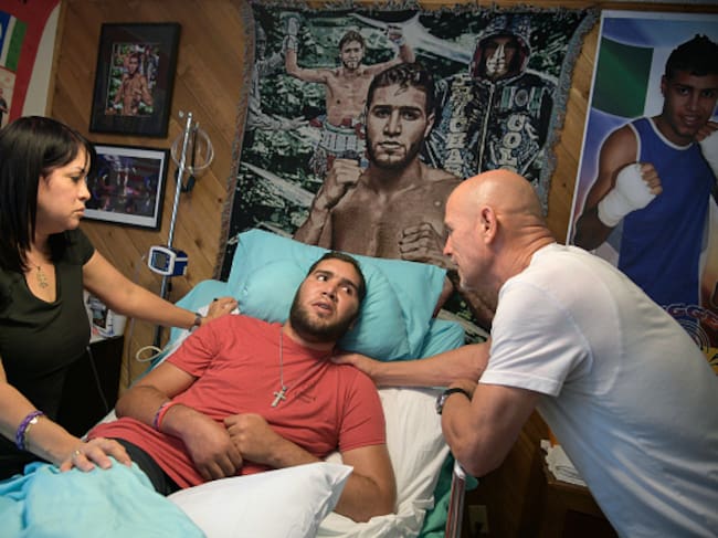 WINTER PARK, FL-MAY 22: Nieves Melendez, left, and Richard Colon tend to their son, former professional boxer Prichard Colon, while he lies in a vegetative state in his bedroom at his family home in Winter Park, Fla., Monday, May 22, 2017. Prichard Colon suffered a traumatic brain injury during his bout against Terrel Williams. (Photo by Phelan M. Ebenhack/For The Washington Post via Getty Images)